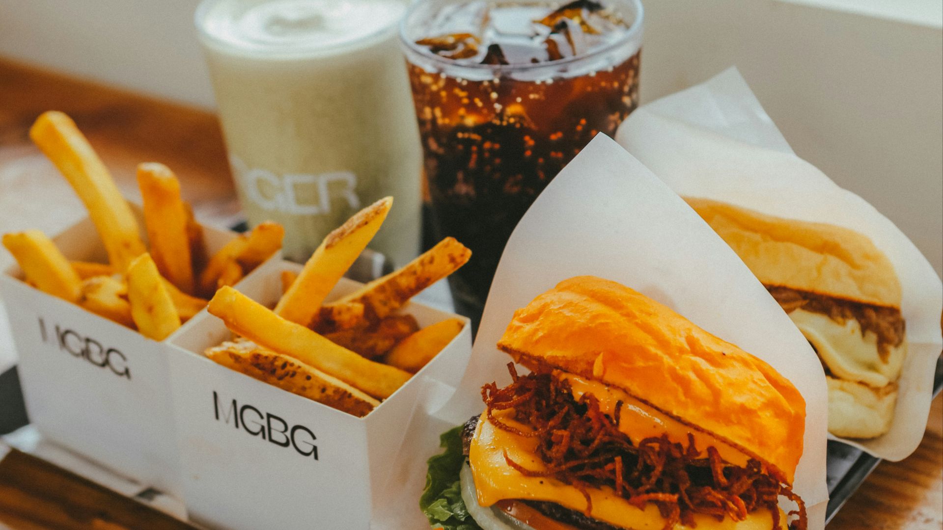 Burger, fries, and drinks on a tray