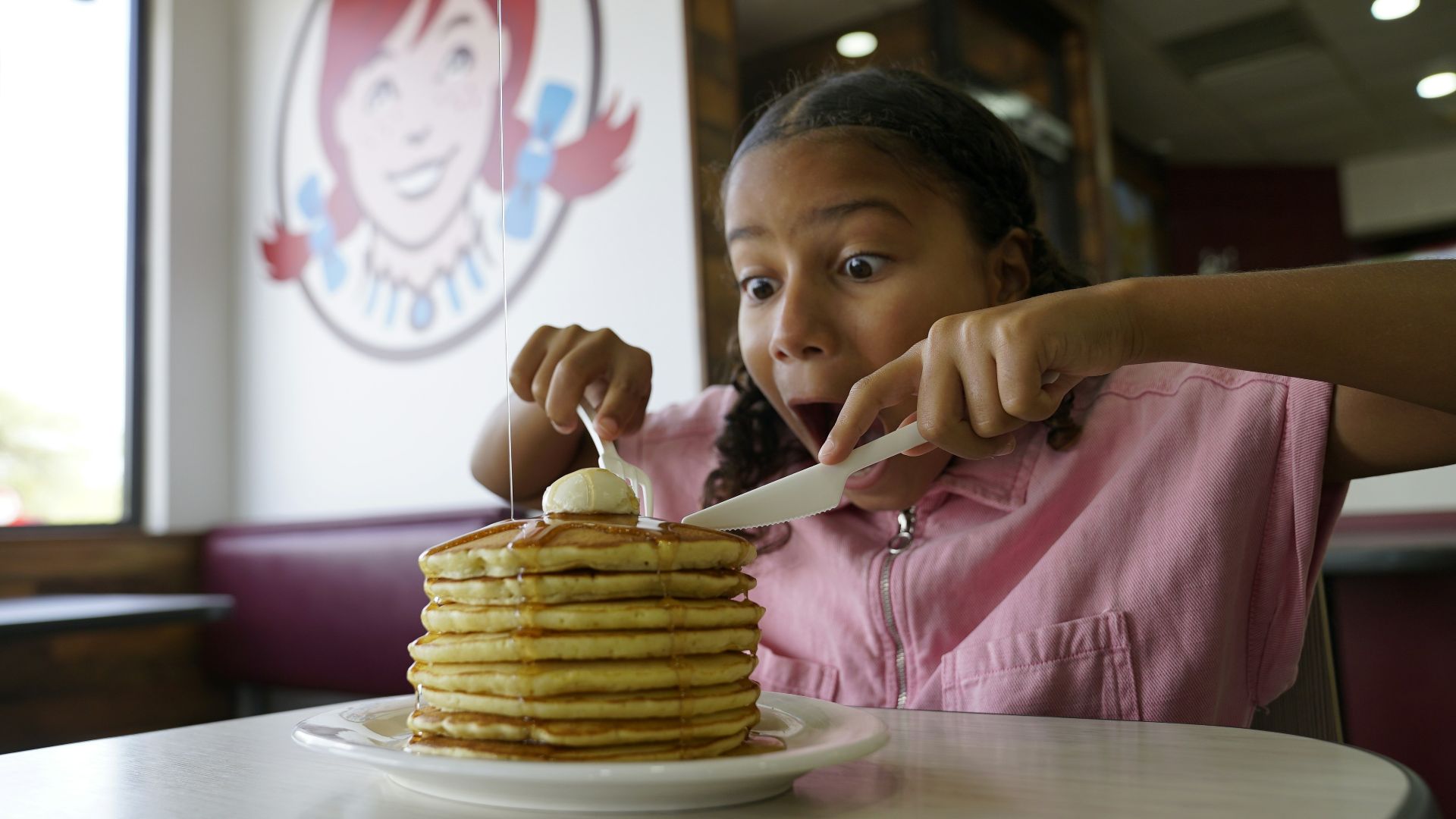Young girl with a stack of pancakes