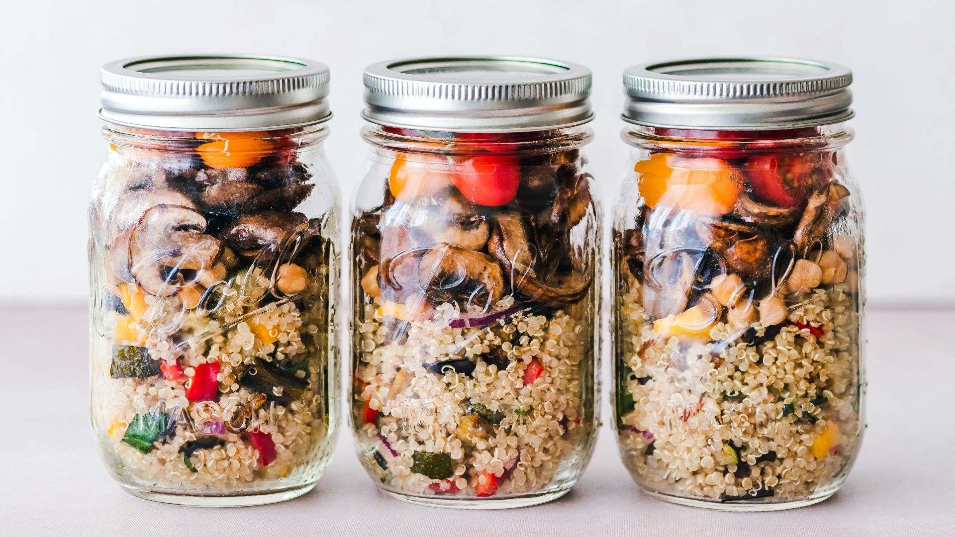 three full clear glass jars with lids