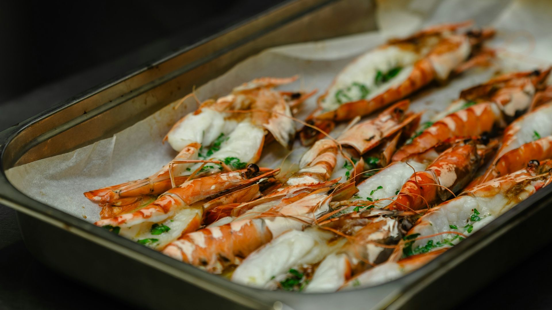 a tray of cooked shrimp on a table