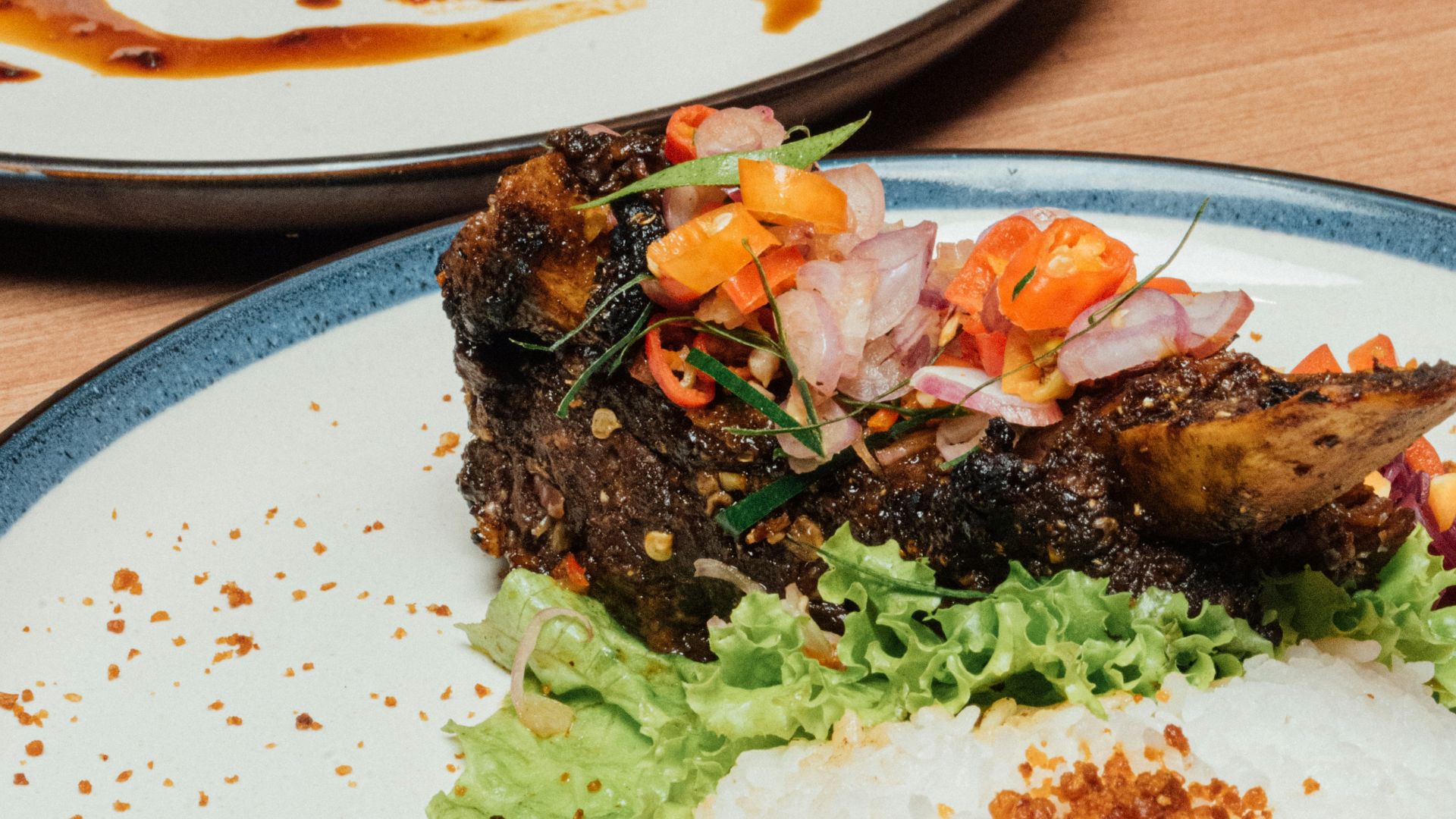 two plates of food with chopsticks sticking out of them