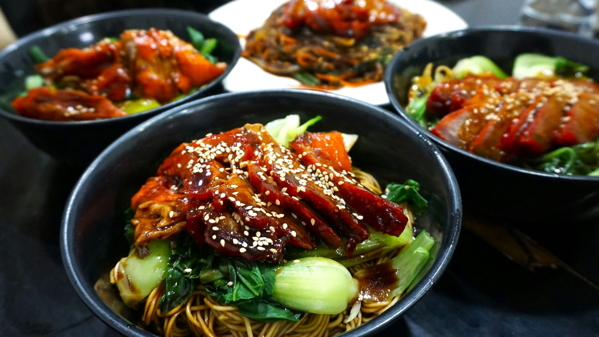 A table topped with three bowls of food