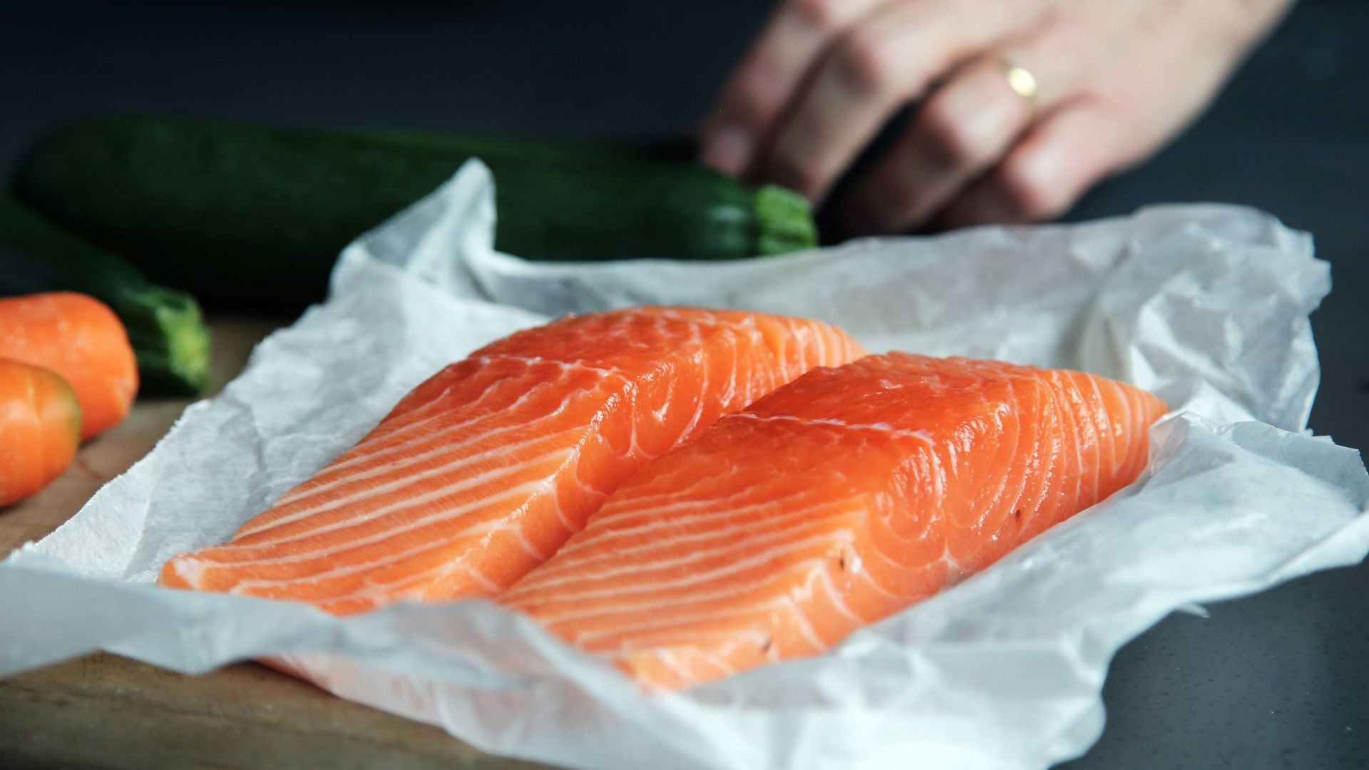 raw fish meat on brown chopping board