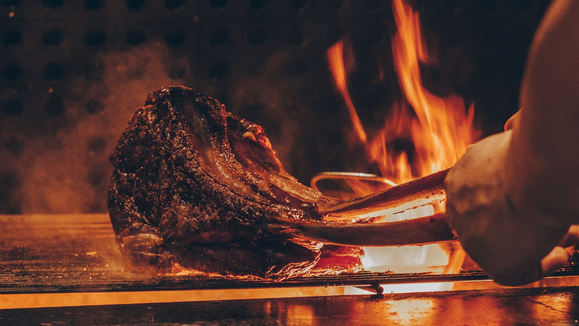 person barbecuing meat