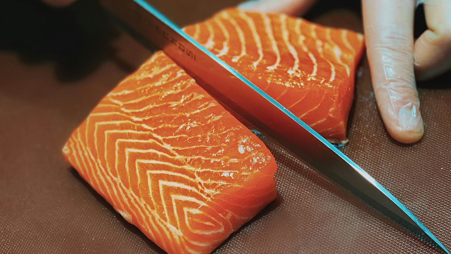 person holding black pencil and brown leather case