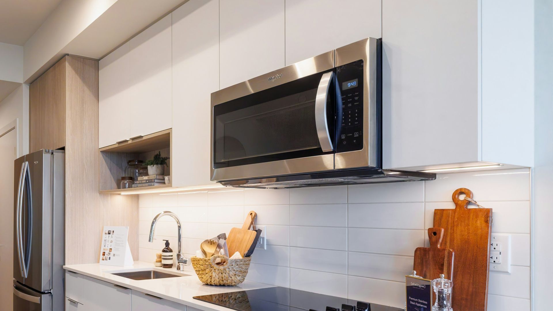 Modern kitchen with stainless steel appliances and island.