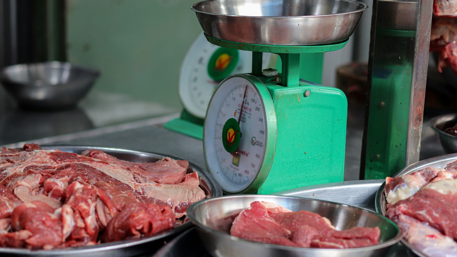 meat is being weighed on a scale in a kitchen