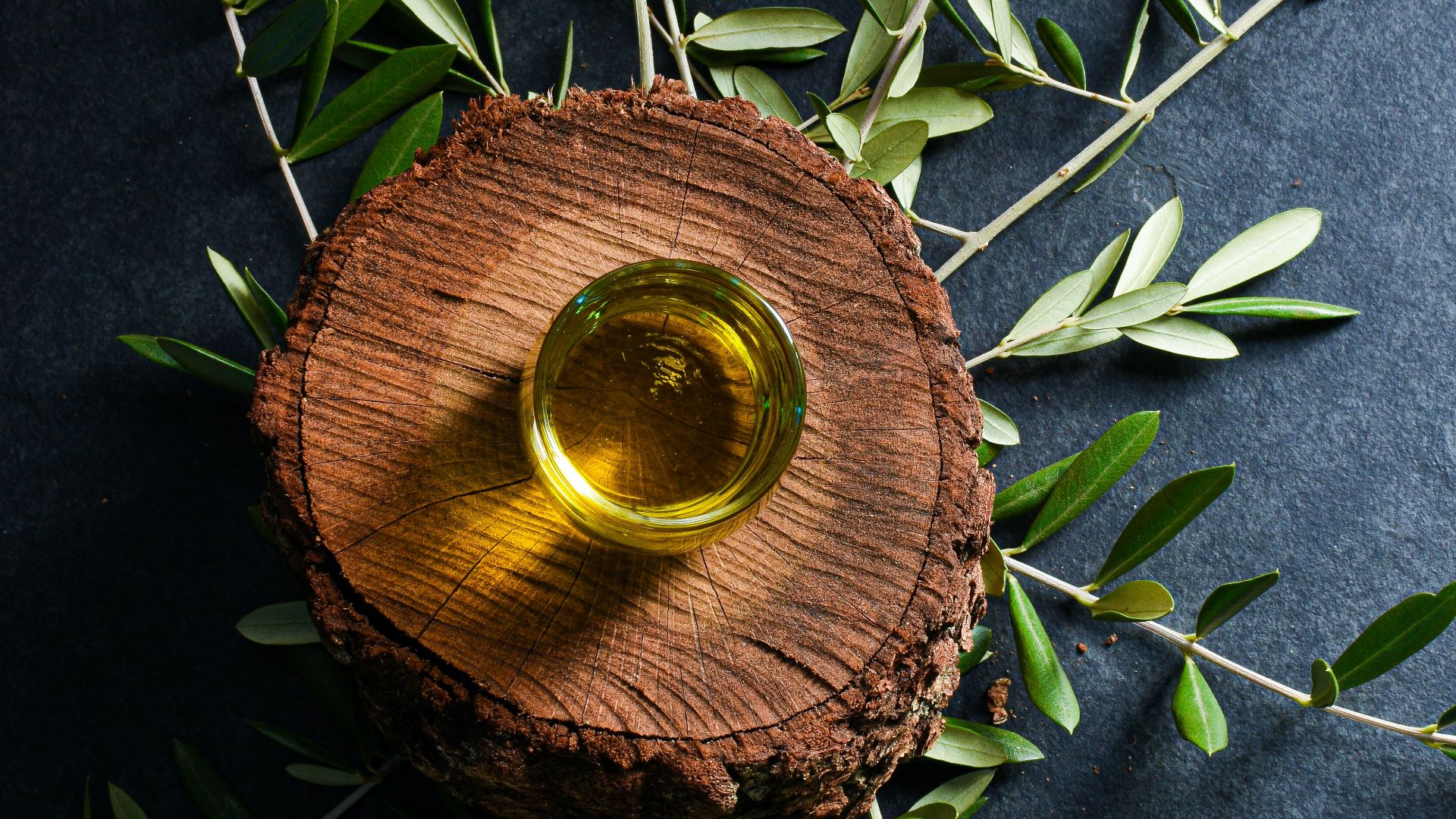 brown round wooden ornament on green leaves