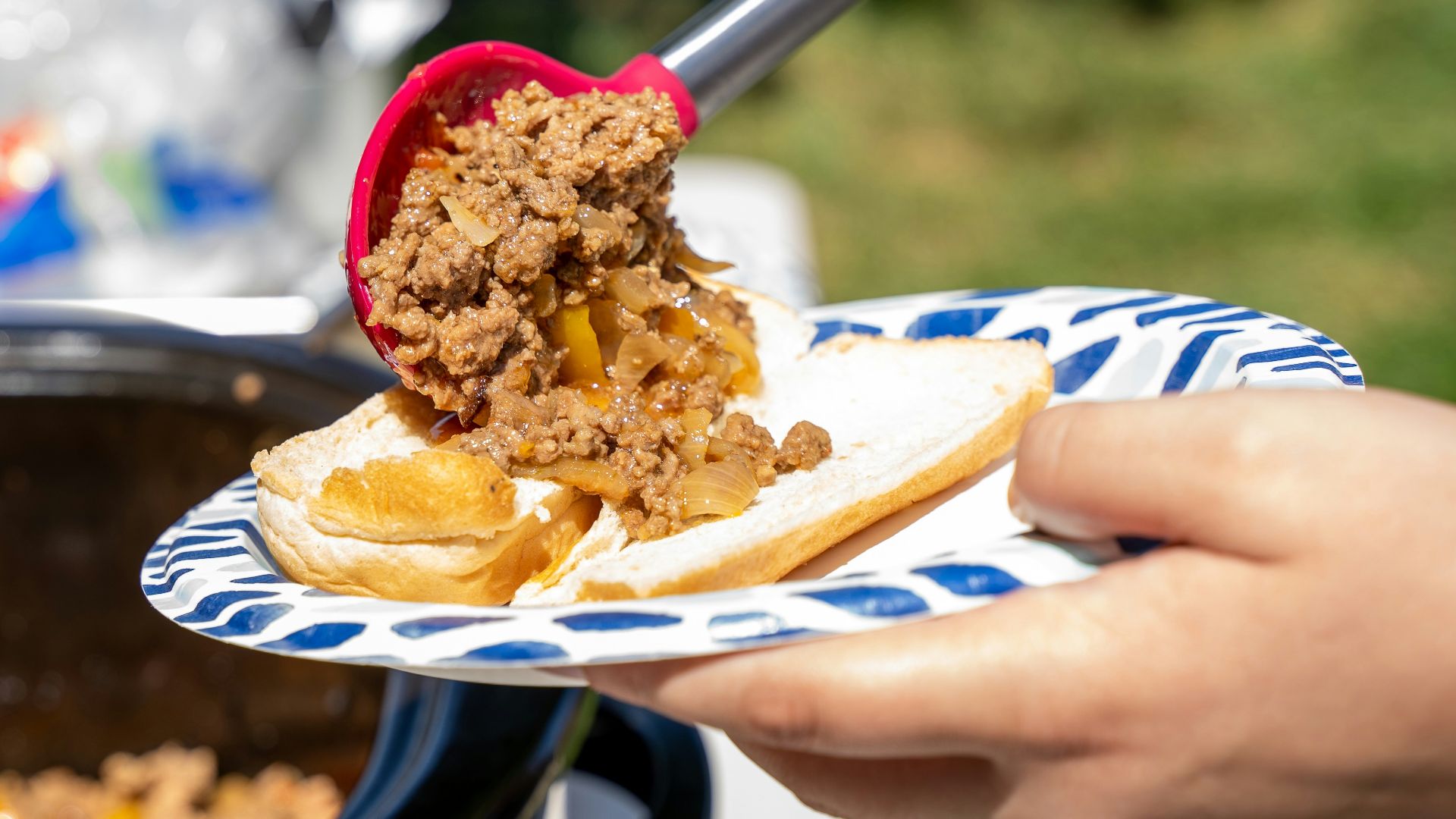 a person cutting a cake with a knife