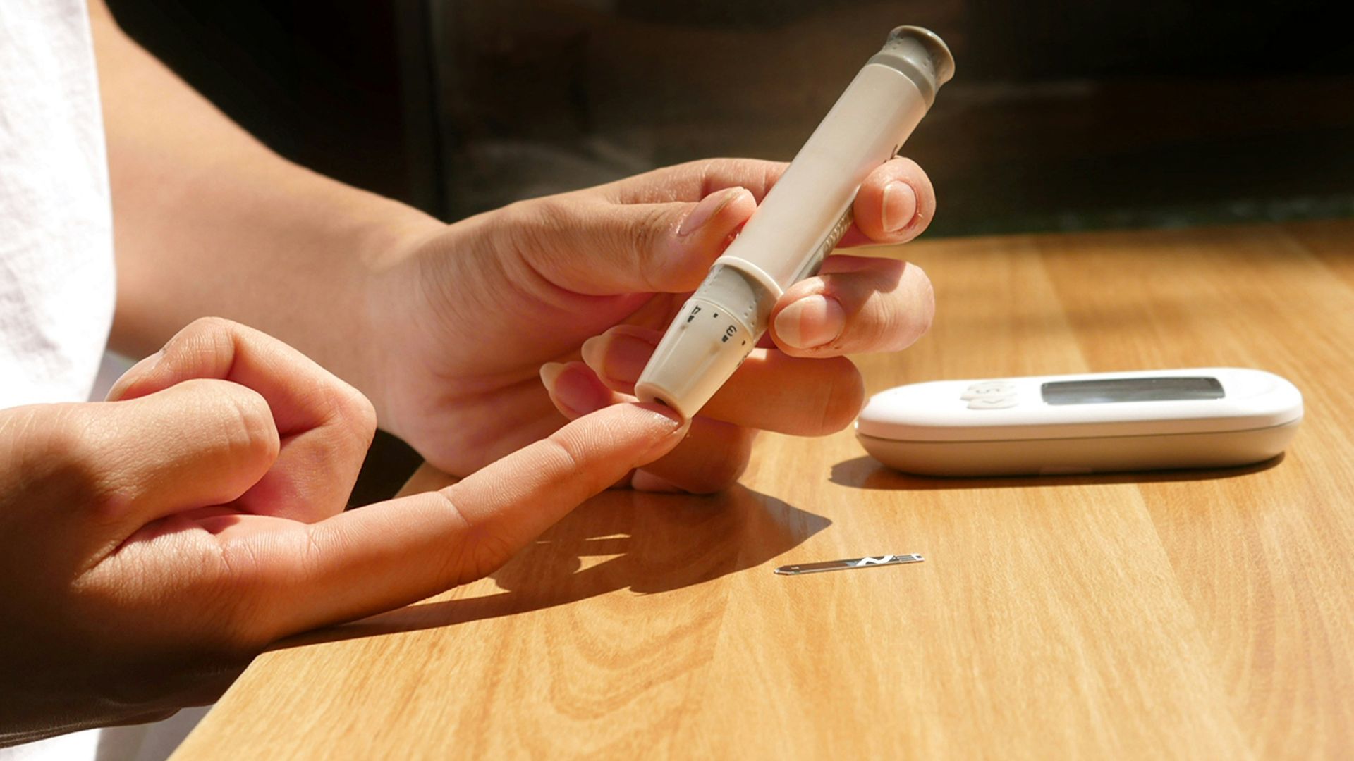 a person sitting at a table with a cell phone