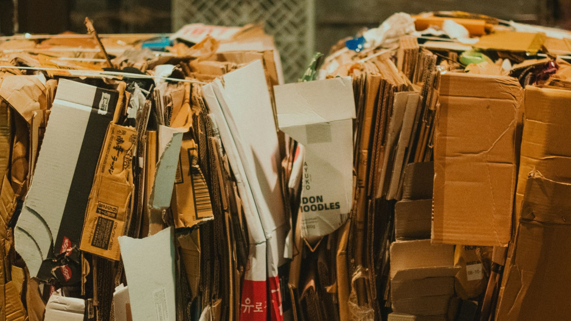 A pile of cardboard sitting on top of a wooden floor