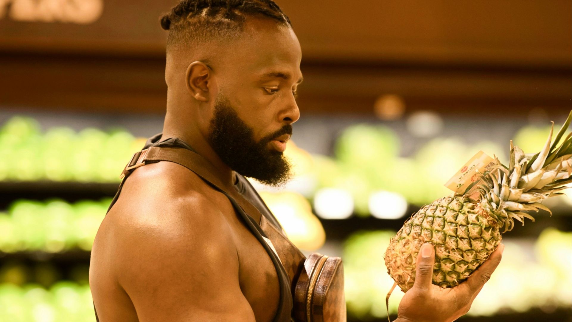 a man holding a pineapple in a grocery store