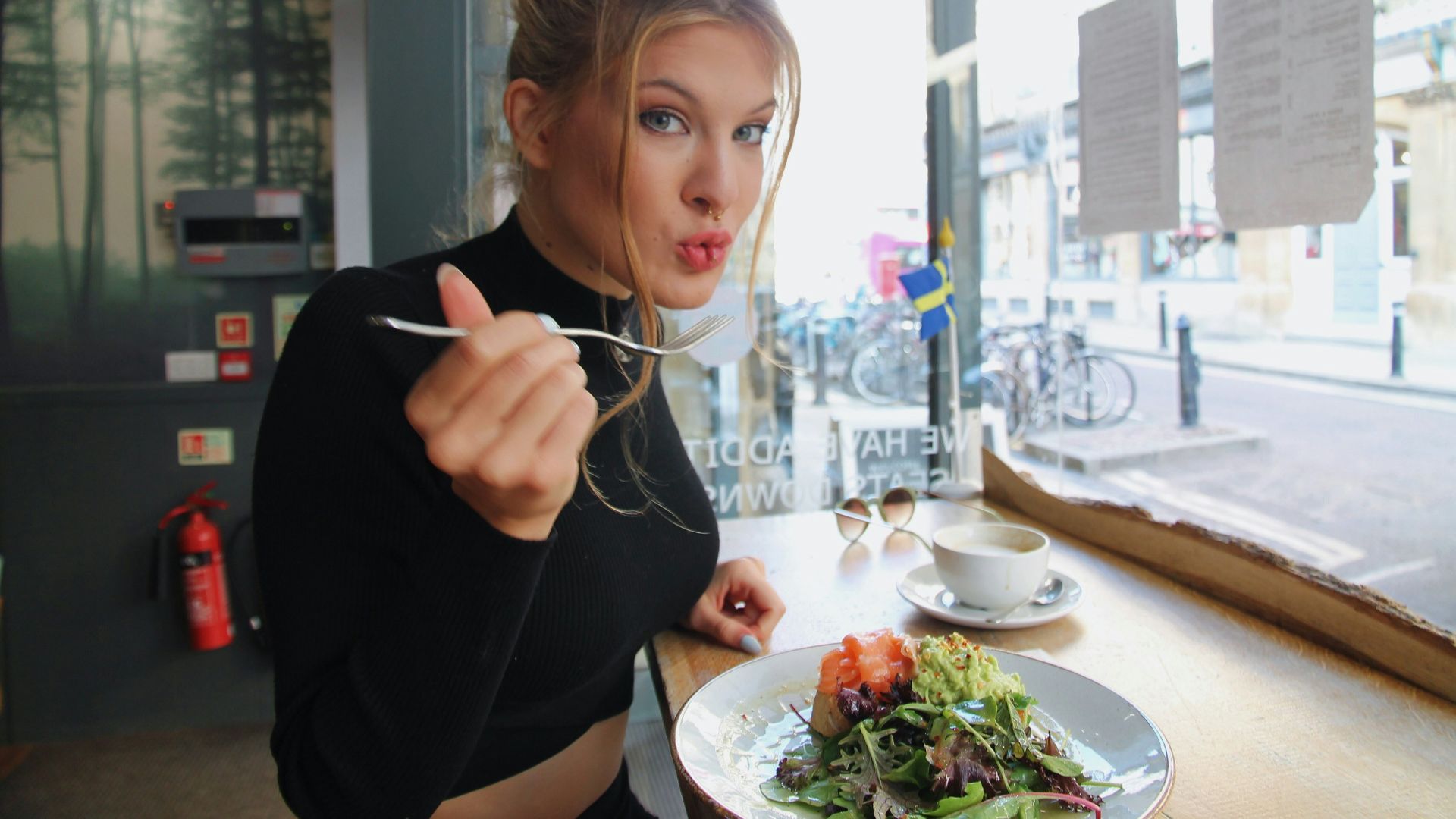woman in black long sleeve shirt eating