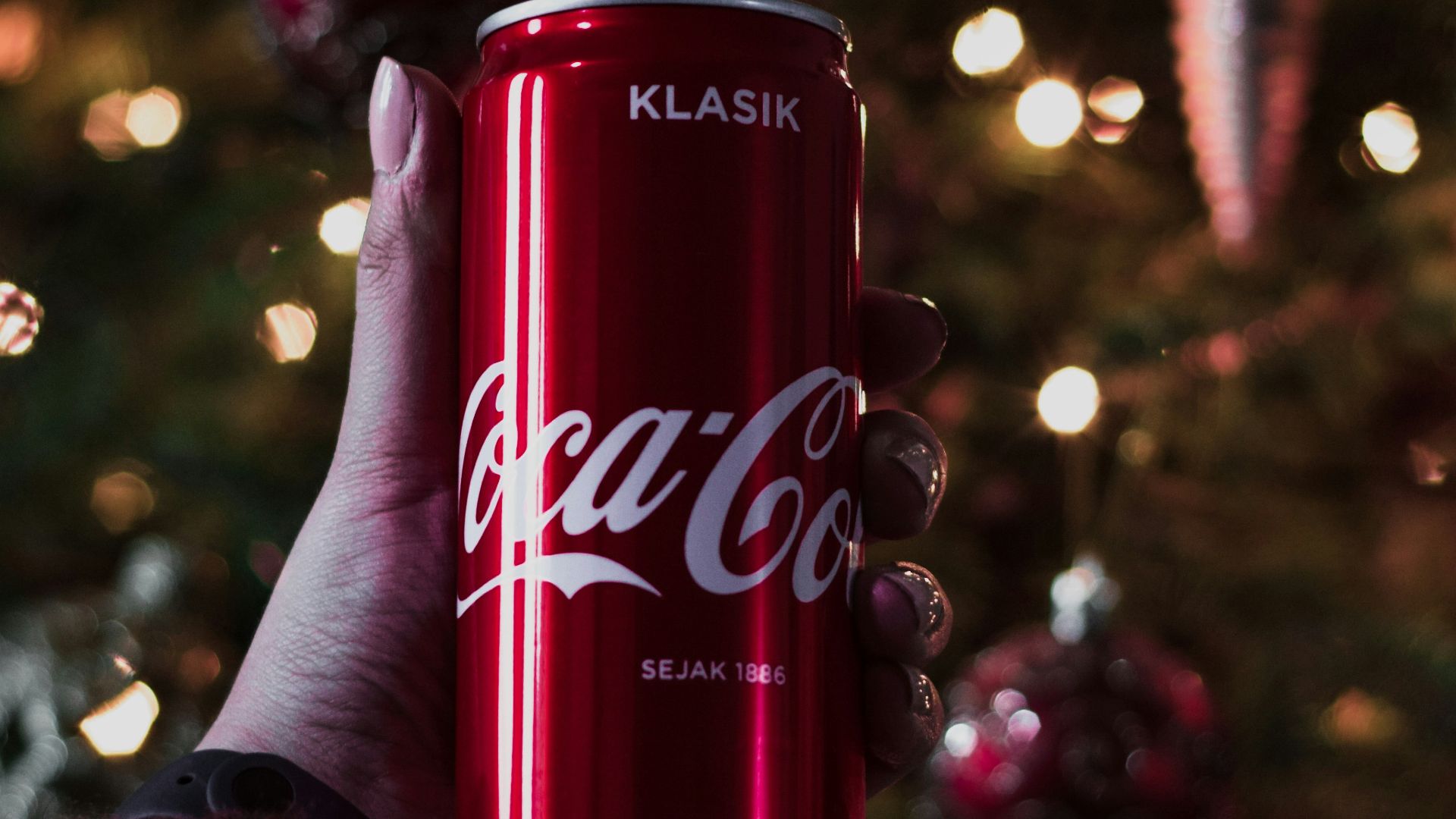 coca cola cherry can on persons hand