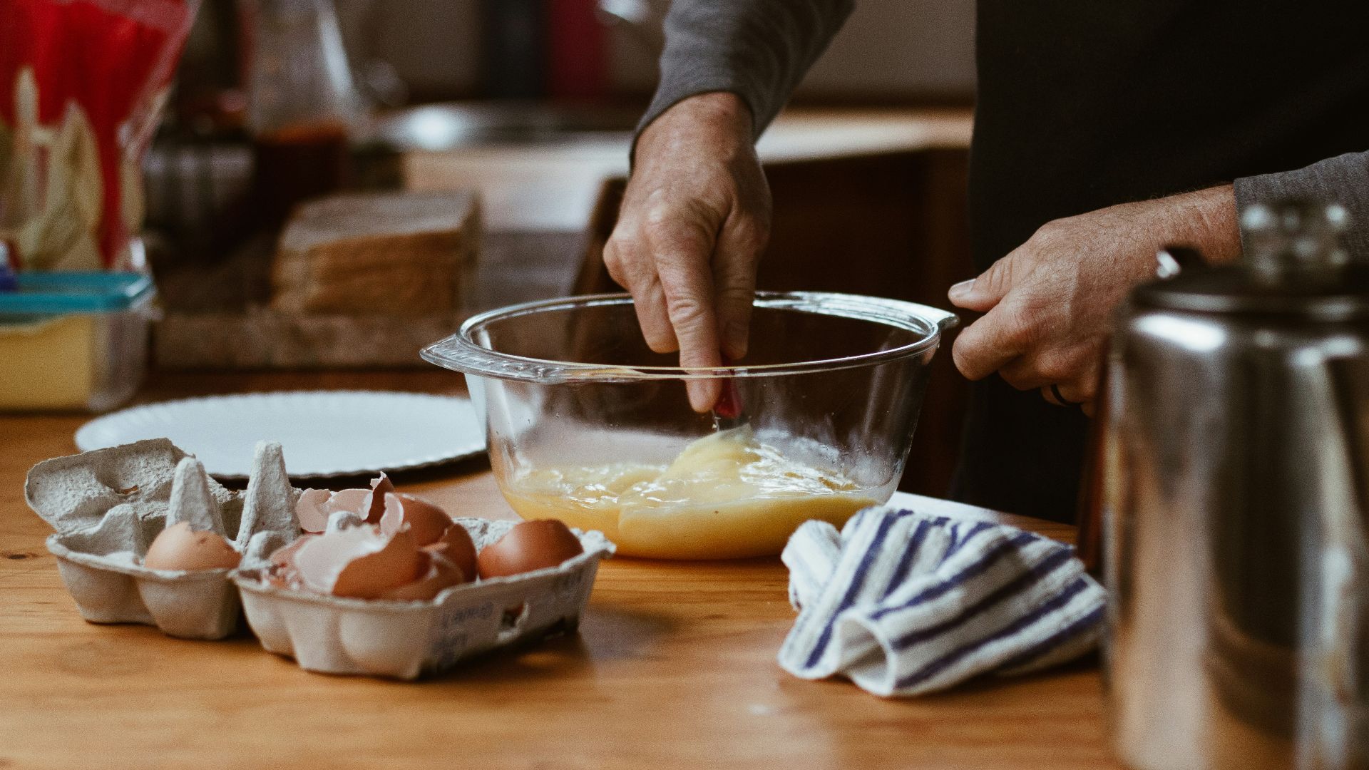 person holding clear glass bowl with brown liquid