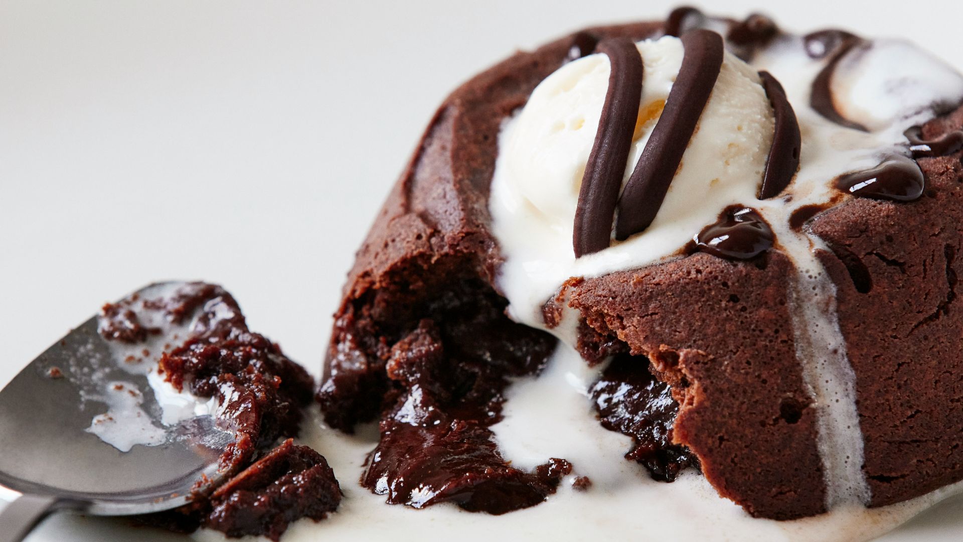 a white plate topped with a piece of cake and ice cream