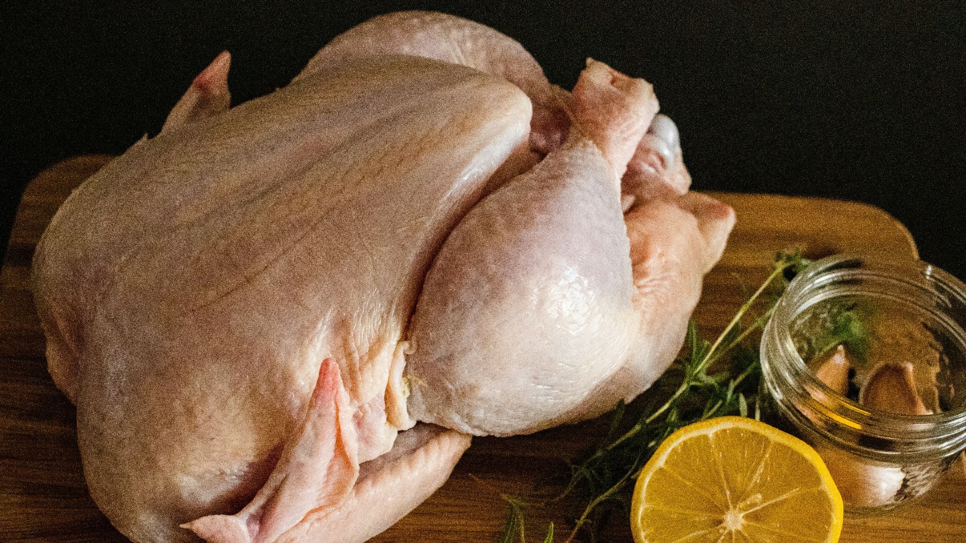 raw chicken meat on brown wooden chopping board