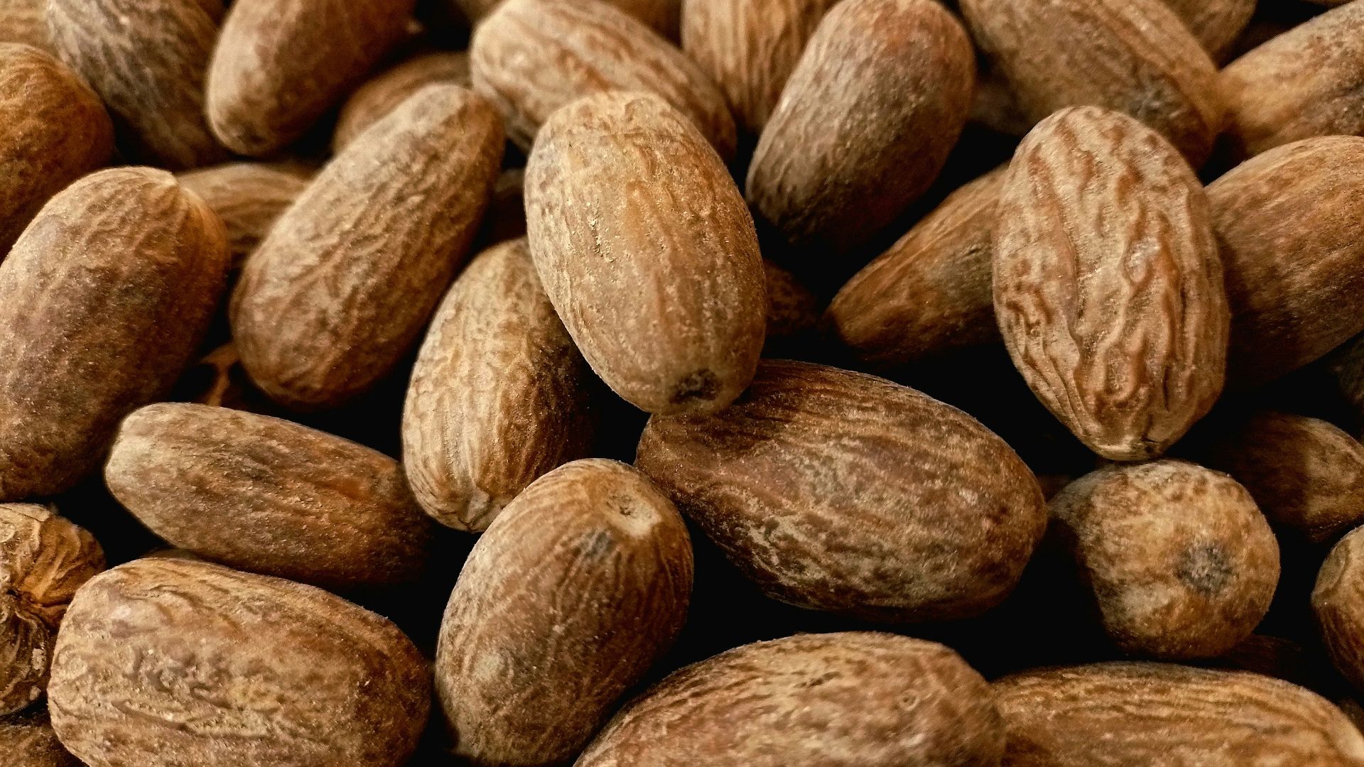 a pile of almonds sitting next to each other