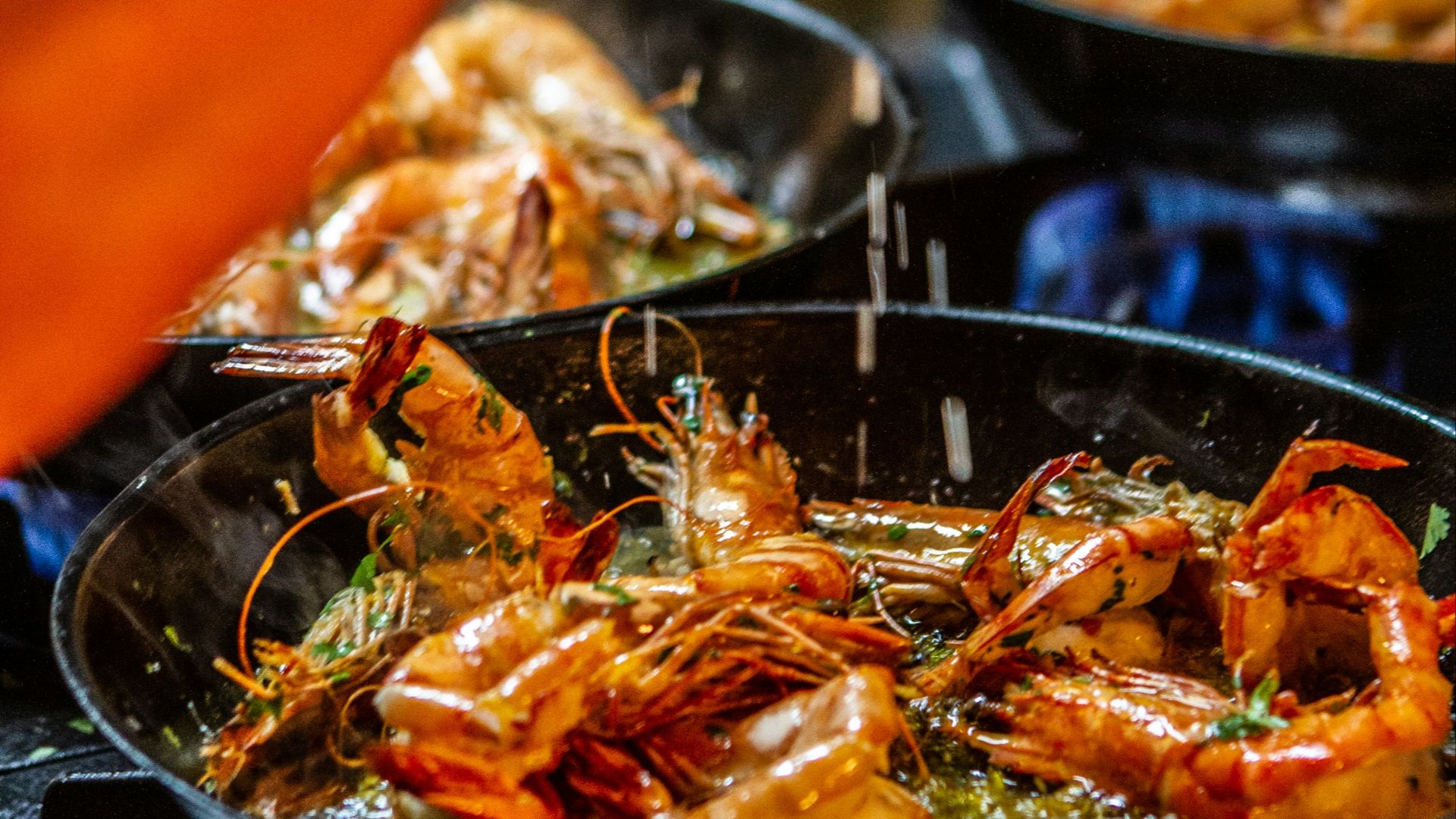 person holding stainless steel tray with cooked food
