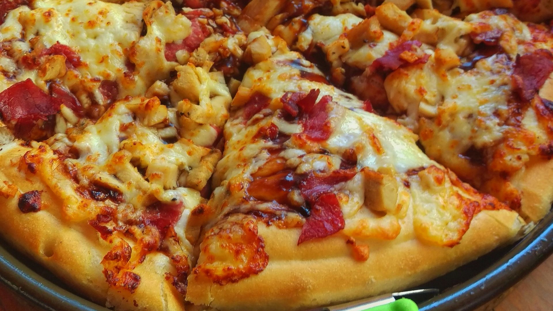 pizza on brown wooden round plate