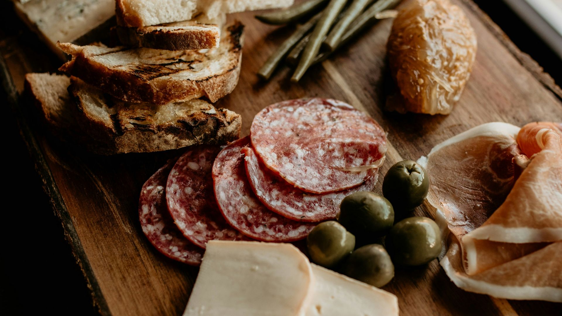 a wooden cutting board topped with lots of food