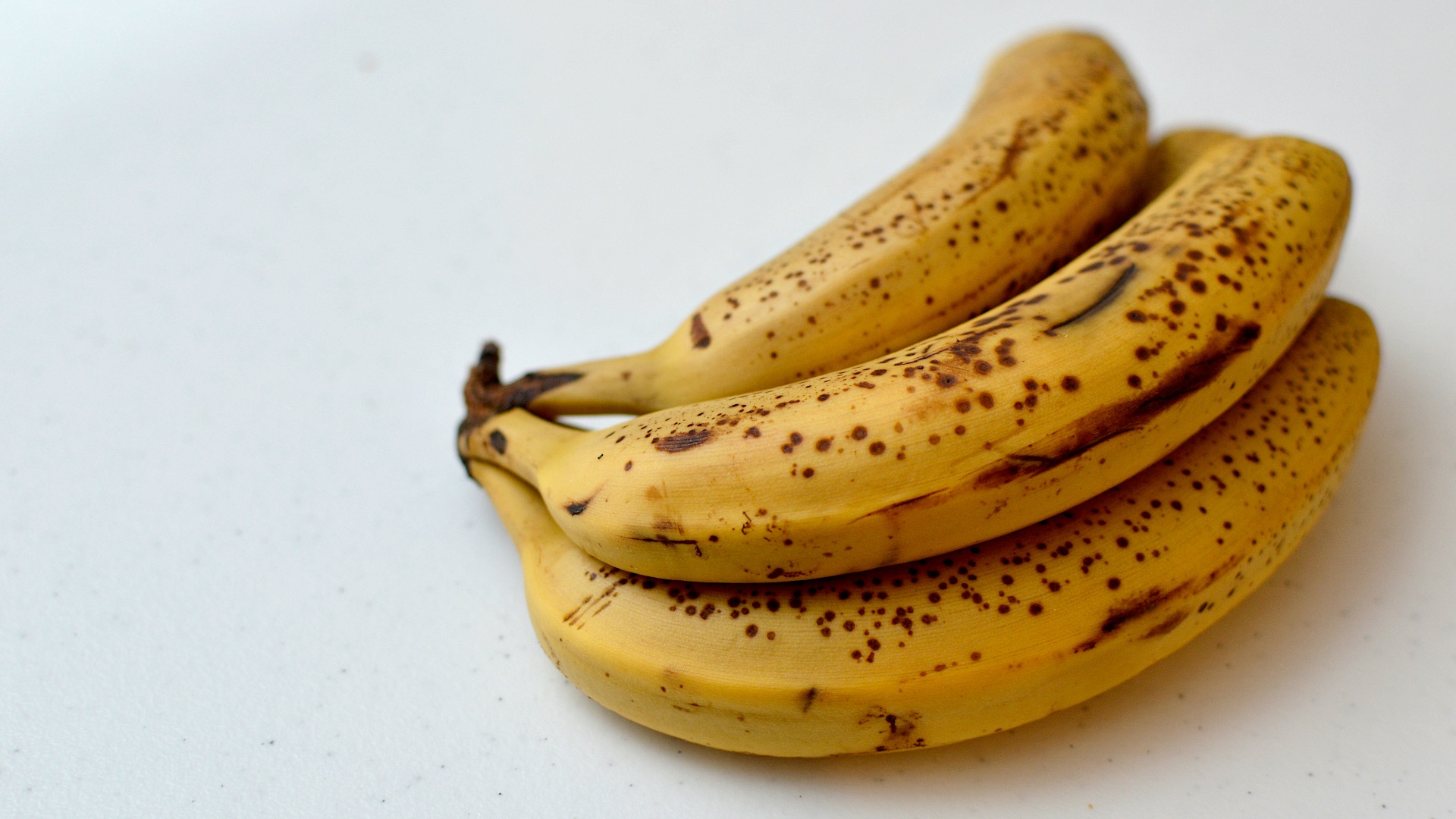 a bunch of ripe bananas sitting on top of a table