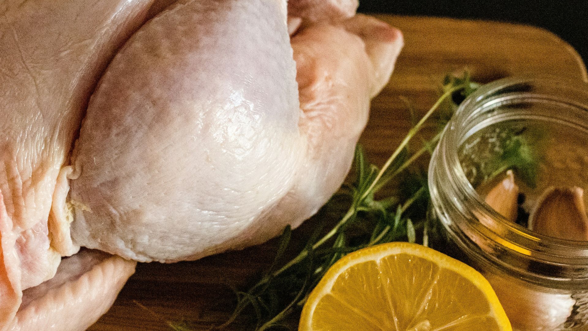 raw chicken meat on brown wooden chopping board