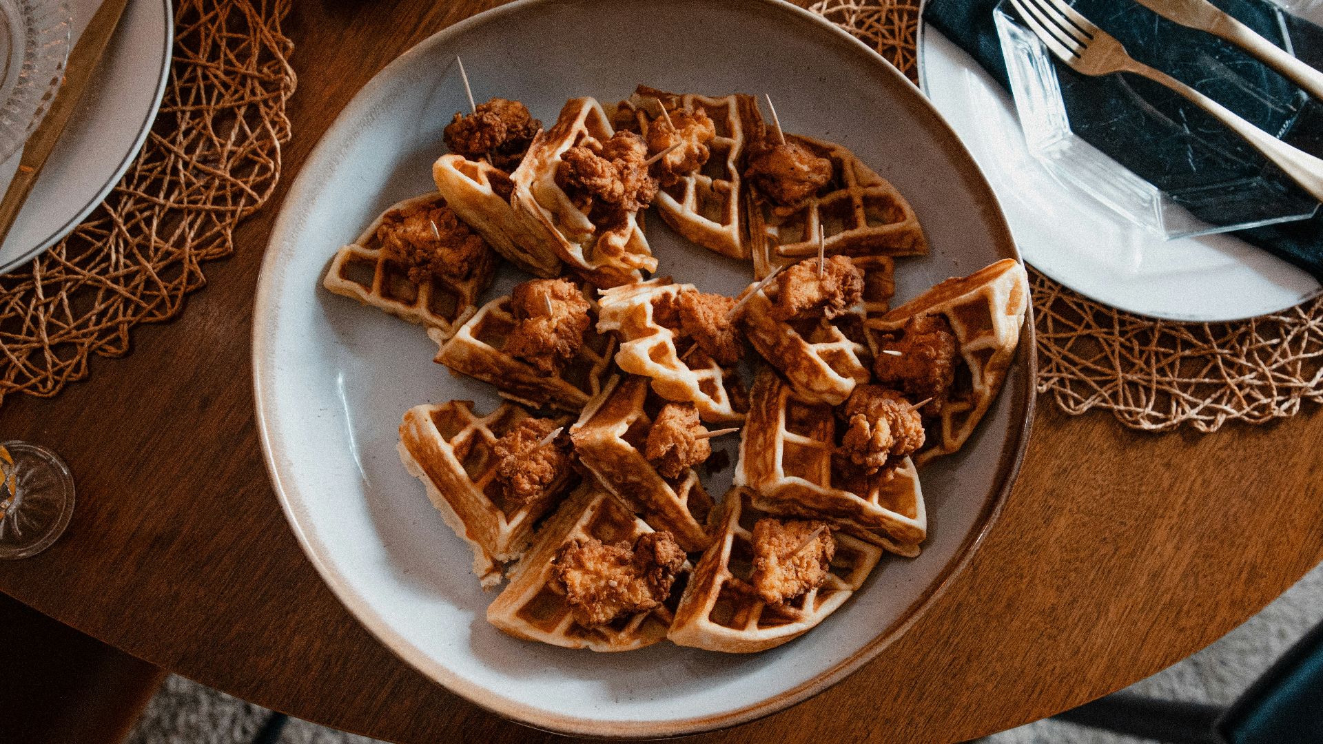 a plate of chicken and waffles on a table