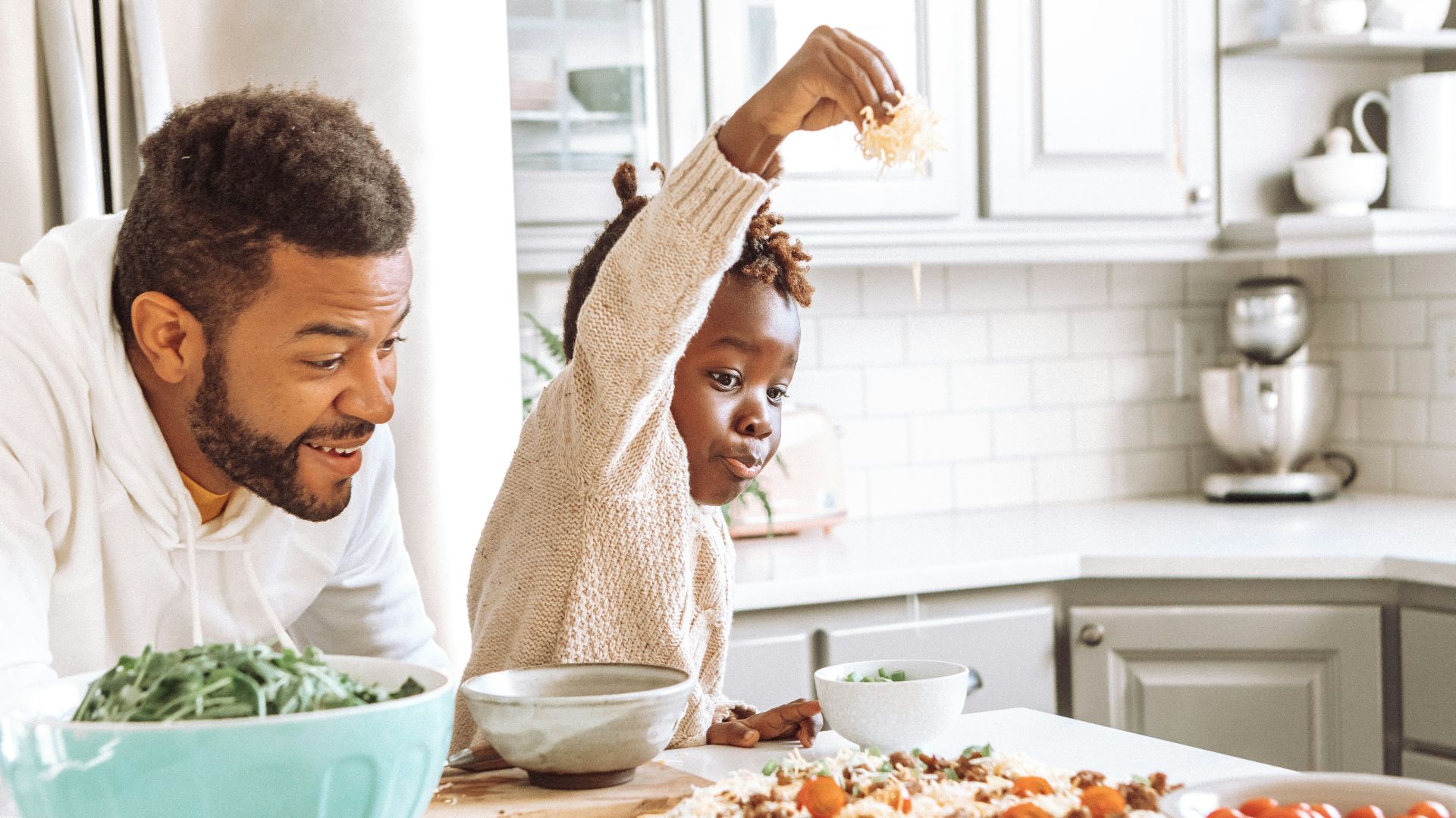 man in white dress shirt holding white ceramic bowl