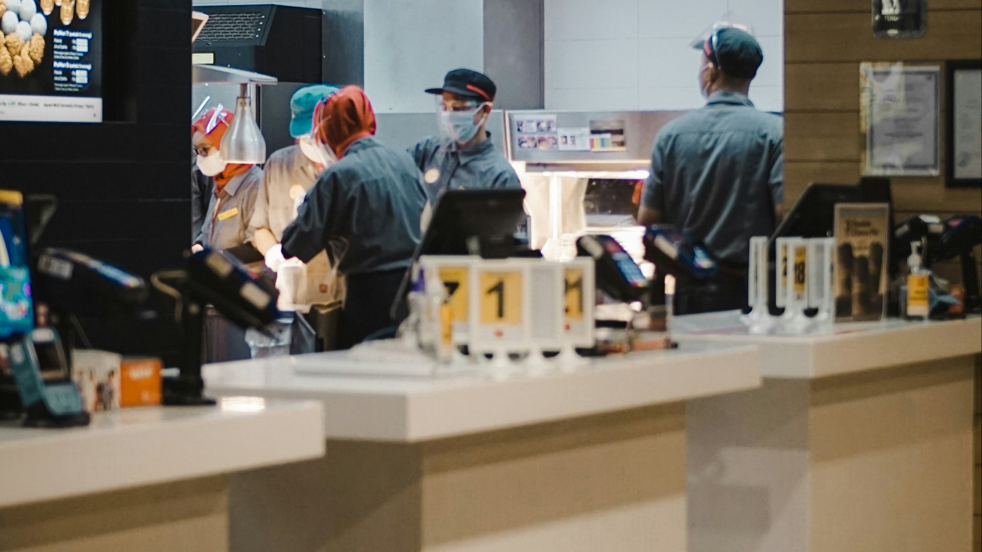 man in blue long sleeve shirt standing beside man in gray long sleeve shirt