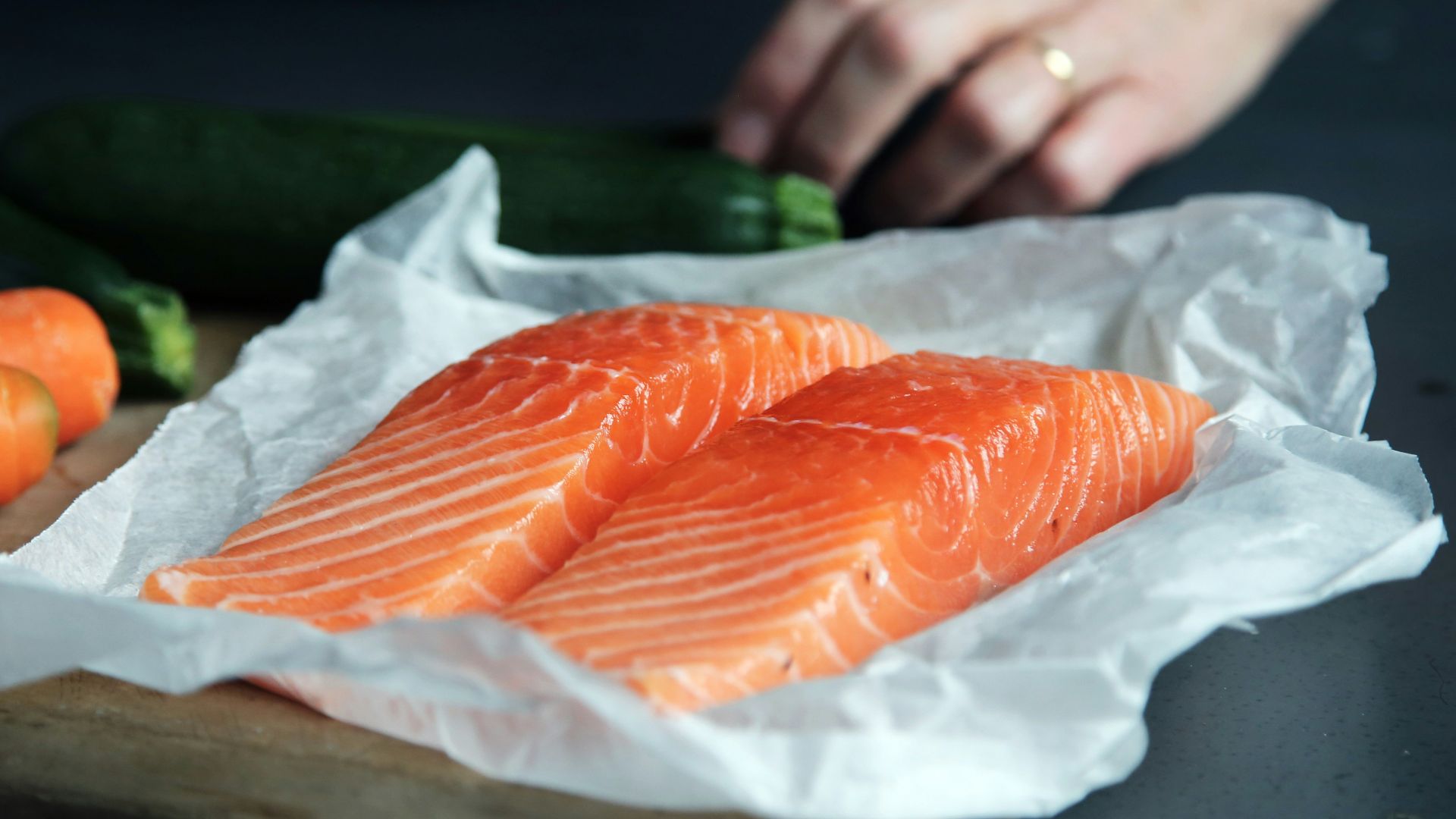 raw fish meat on brown chopping board