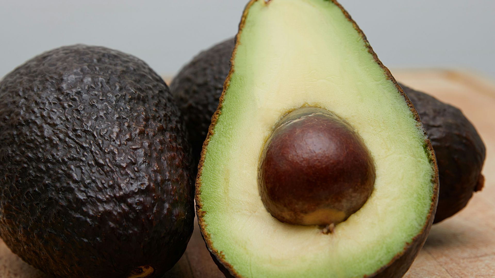 sliced avocado fruit on brown wooden table