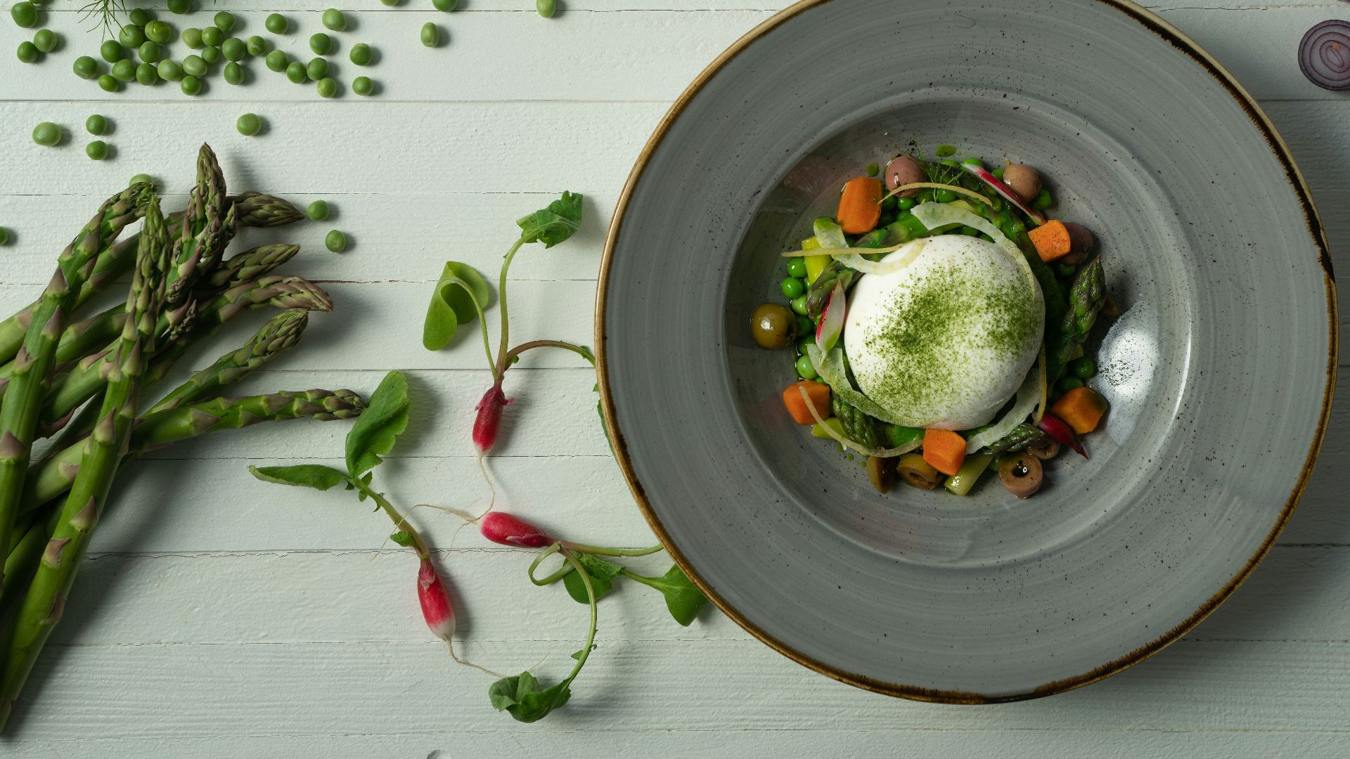 a plate of food with asparagus, carrots, and an egg