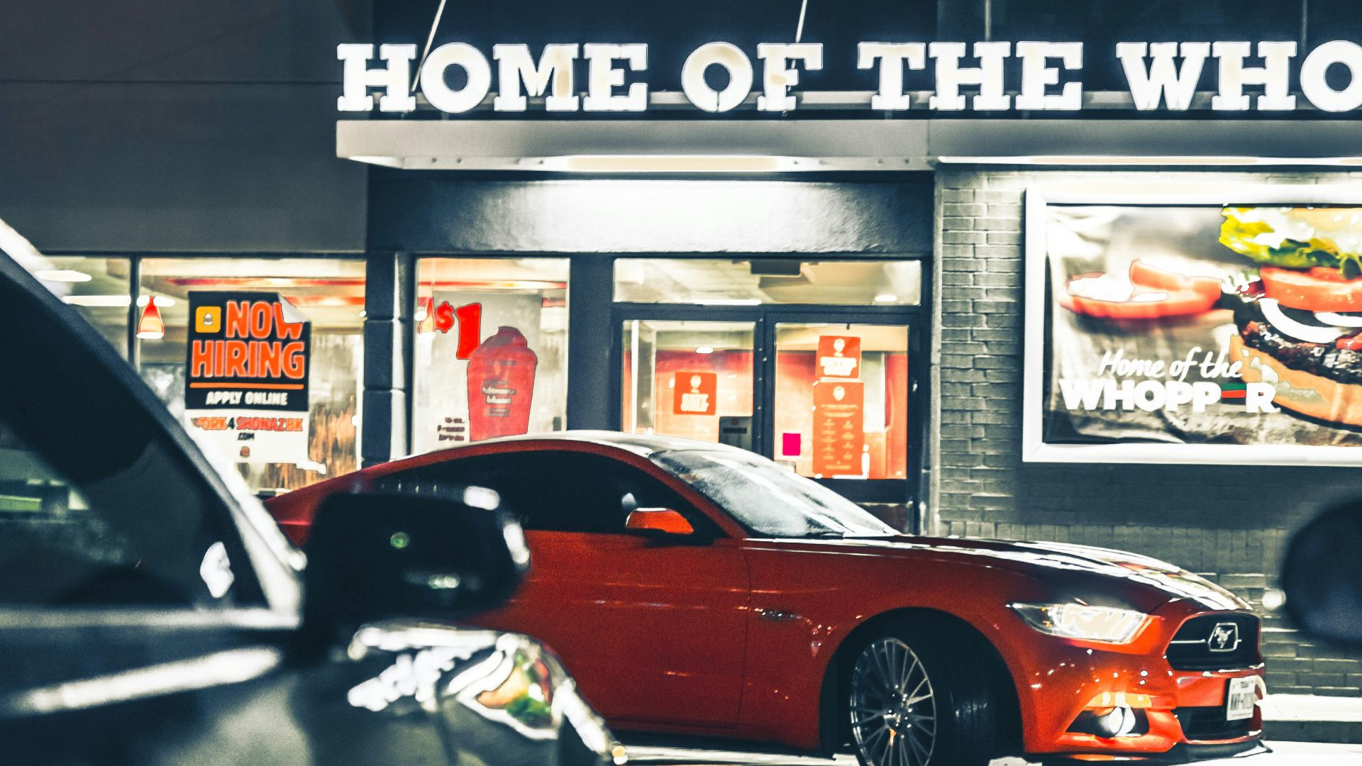 a burger king restaurant with cars parked in front of it