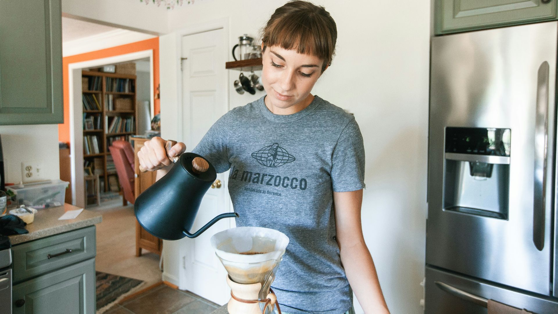 boy in gray crew neck t-shirt holding blue ceramic mug