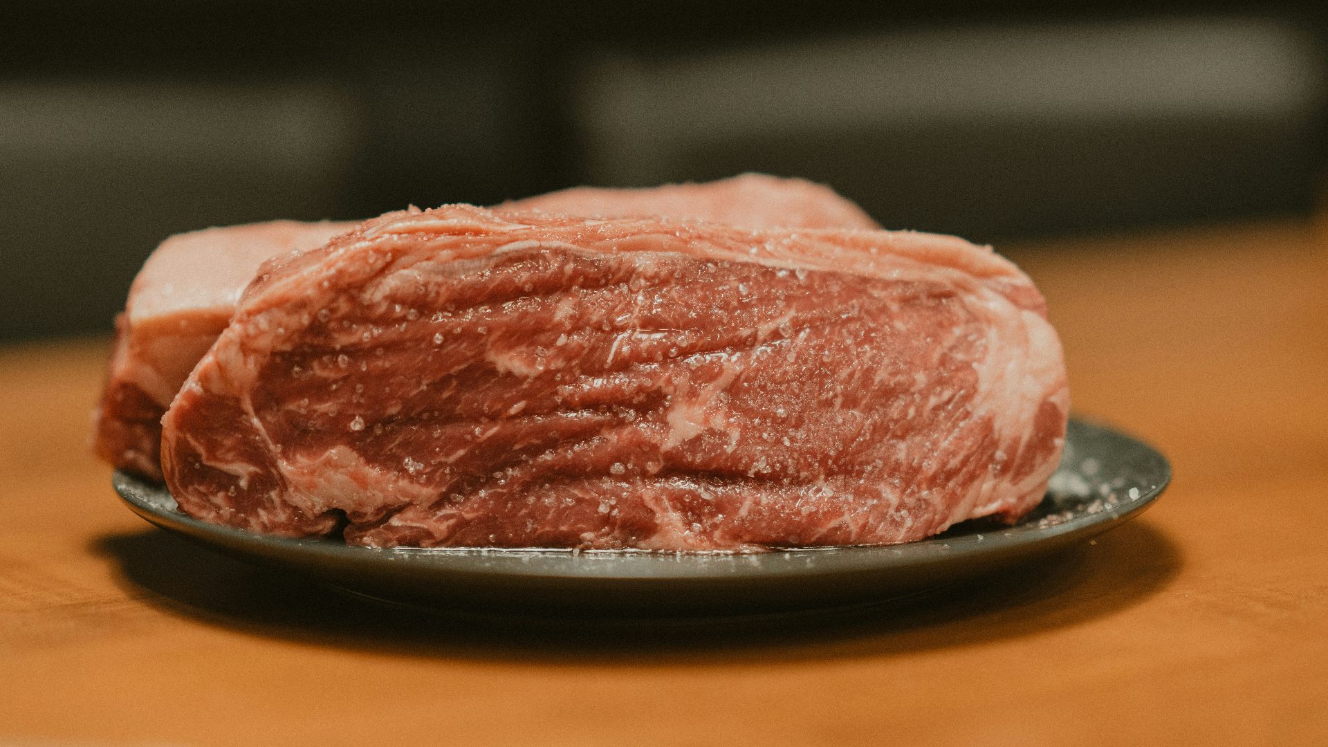 A piece of meat on a plate on a table