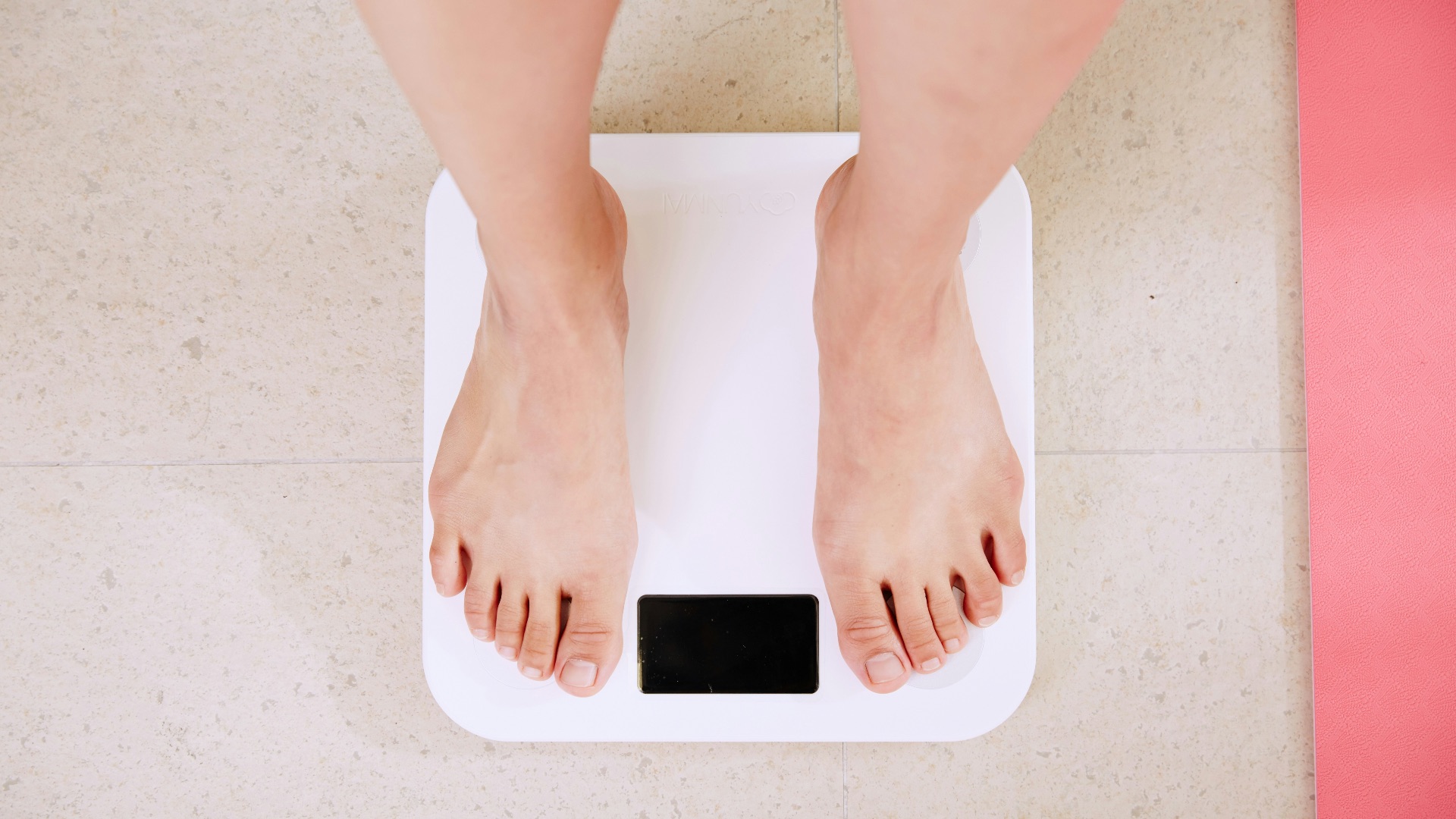 person standing on white digital bathroom scale