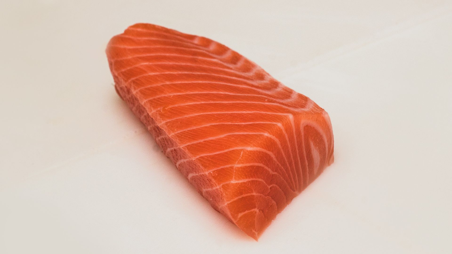 sliced fish meat on white surface