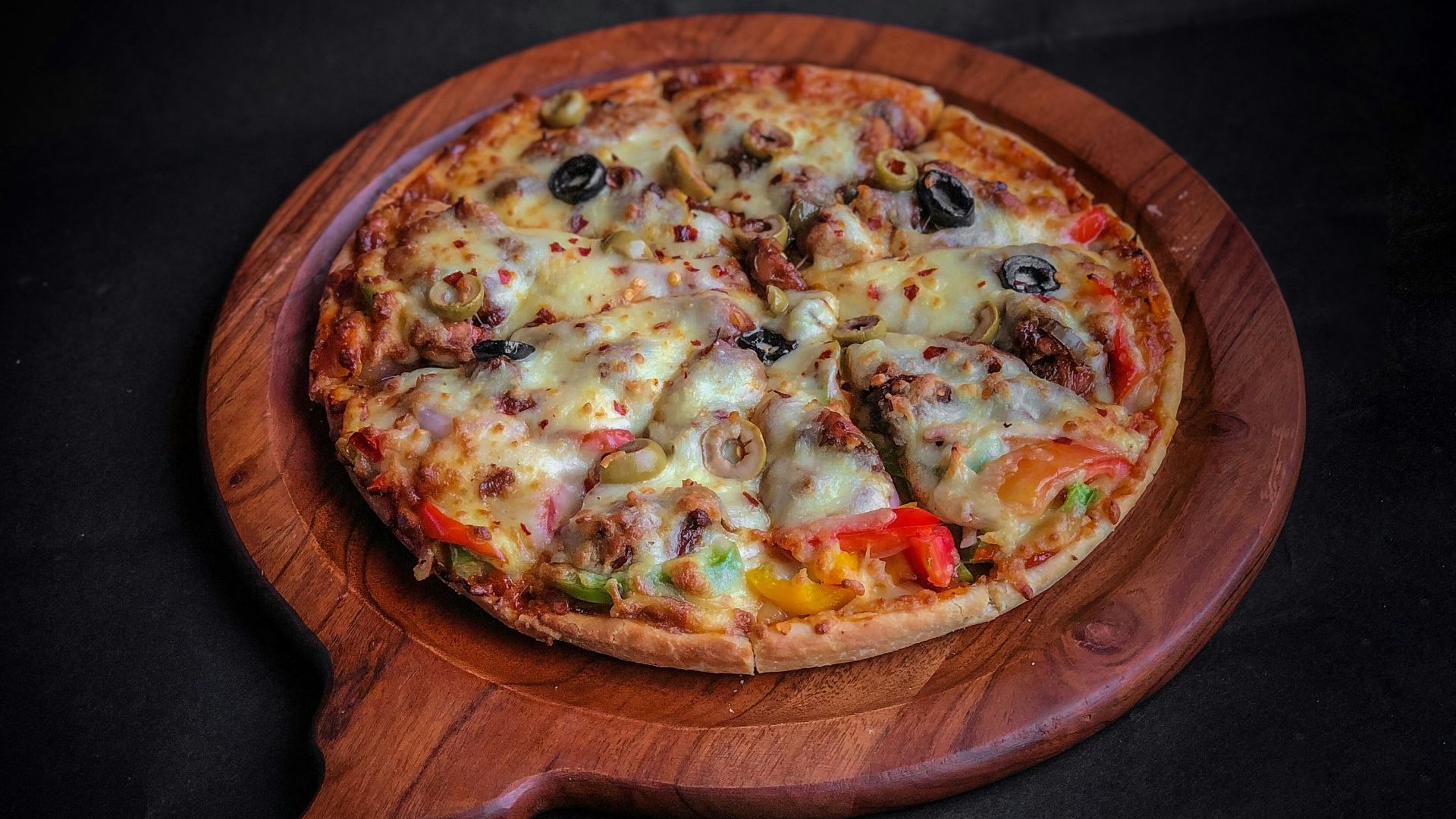 pizza on brown wooden round tray
