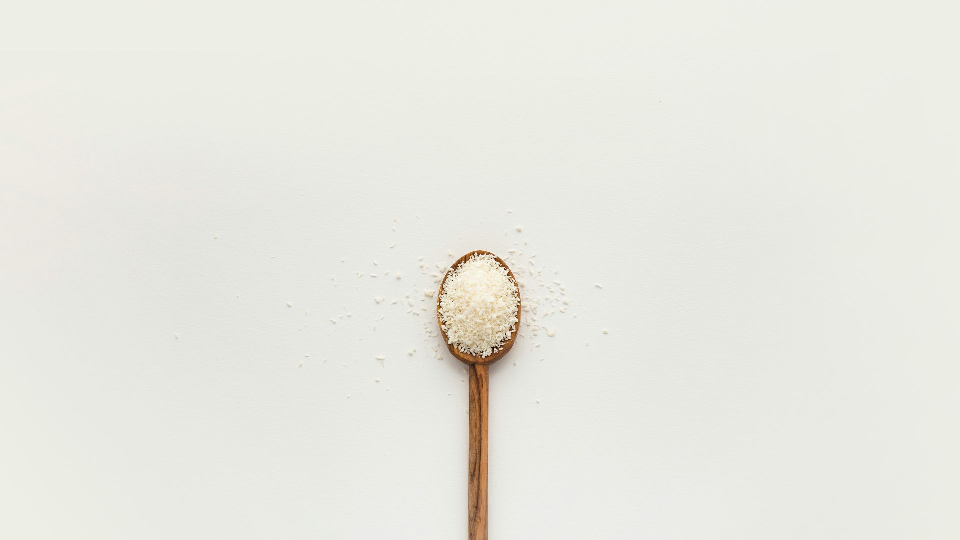 white powder on brown wooden spoon