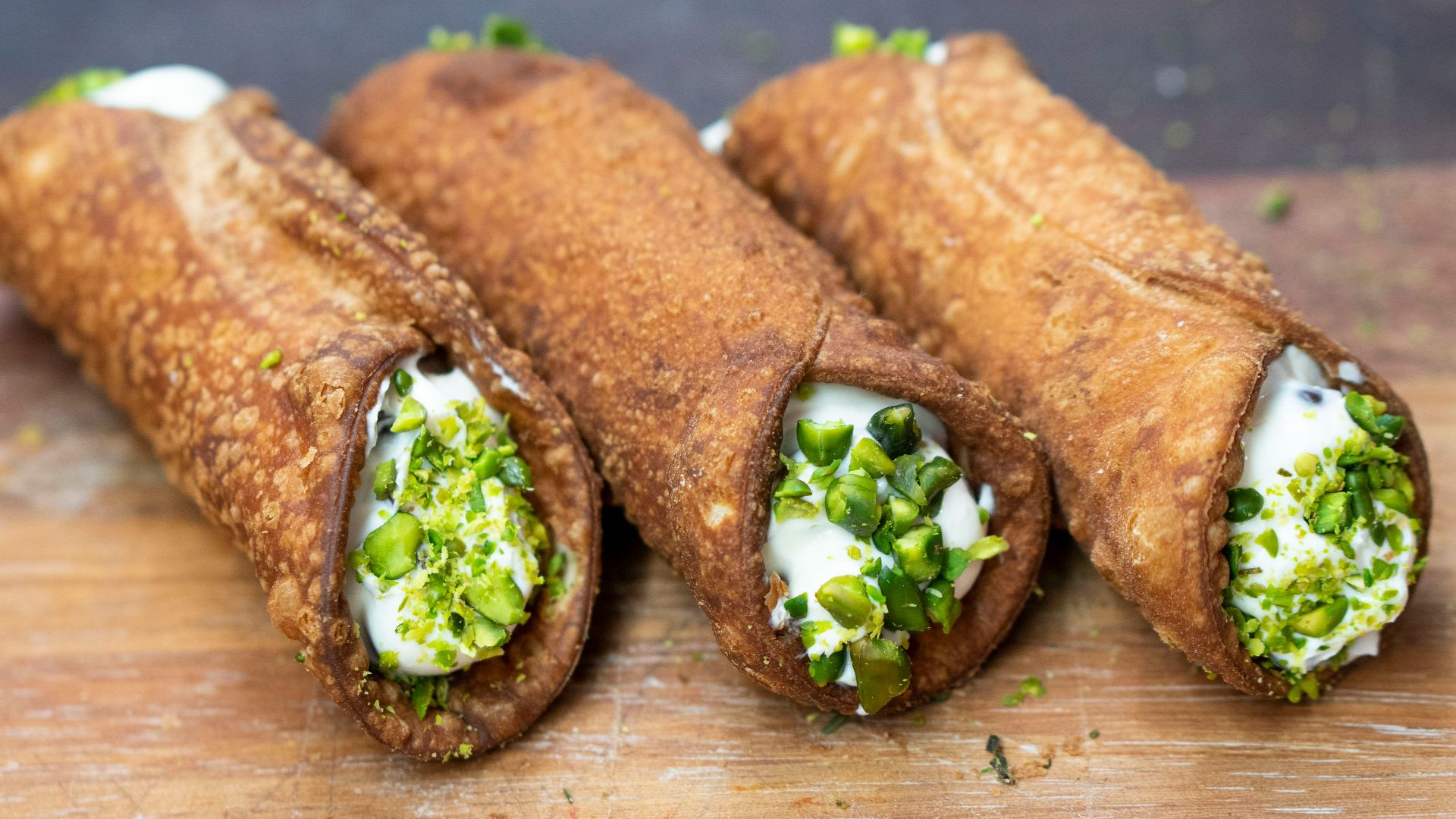 sliced bread with green vegetable on brown wooden table