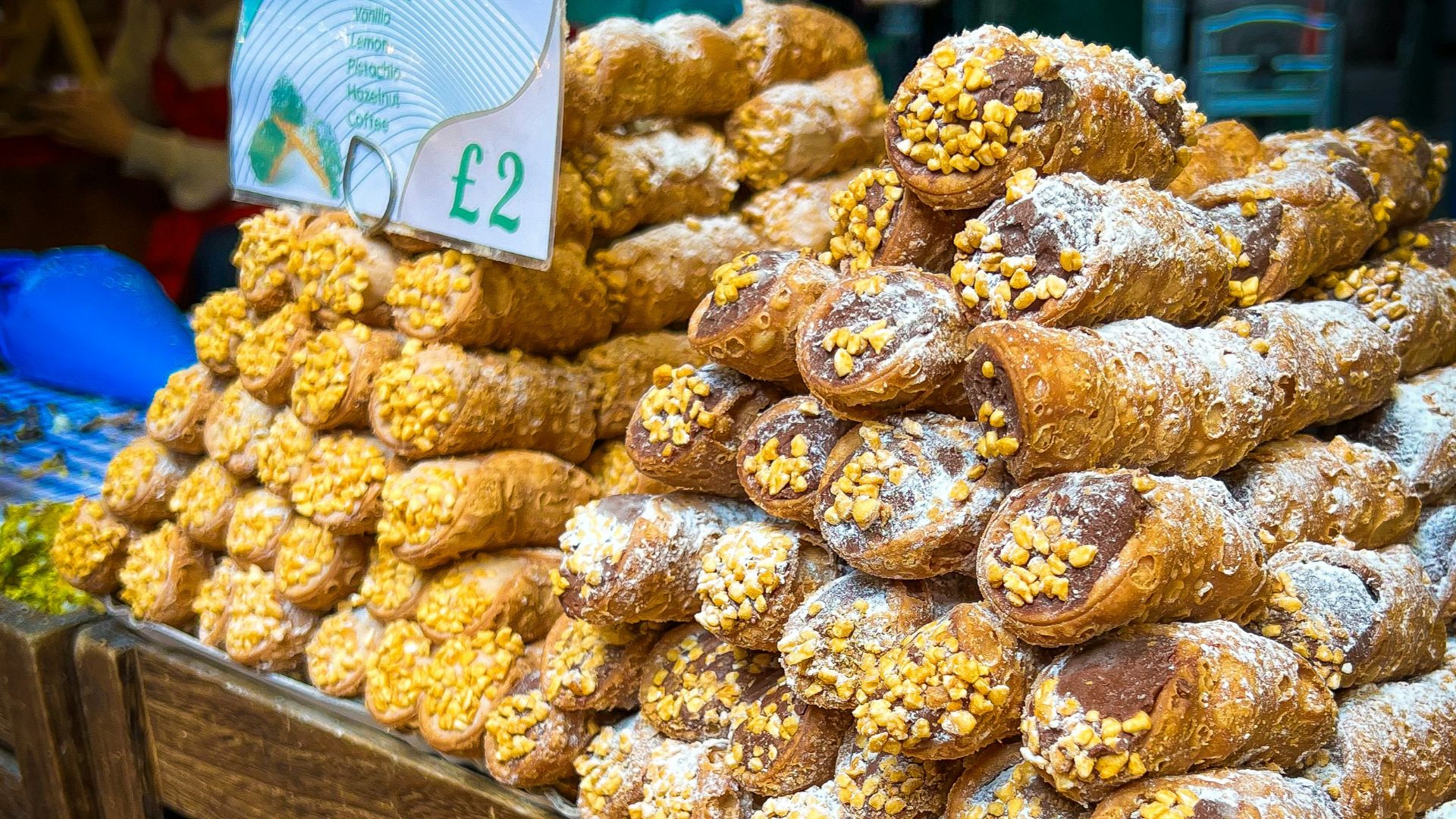 Fresh italian cannoli piled high for sale.