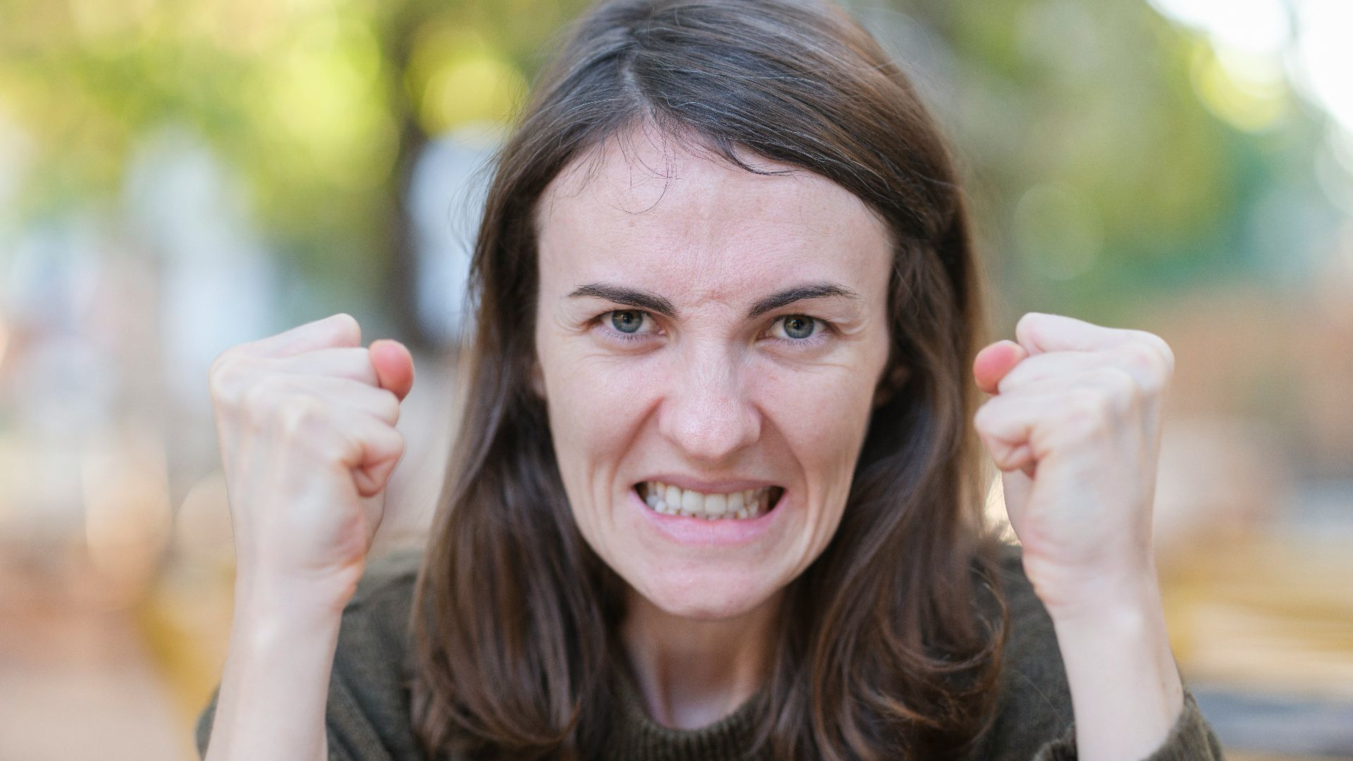 a woman holding her fists up in the air