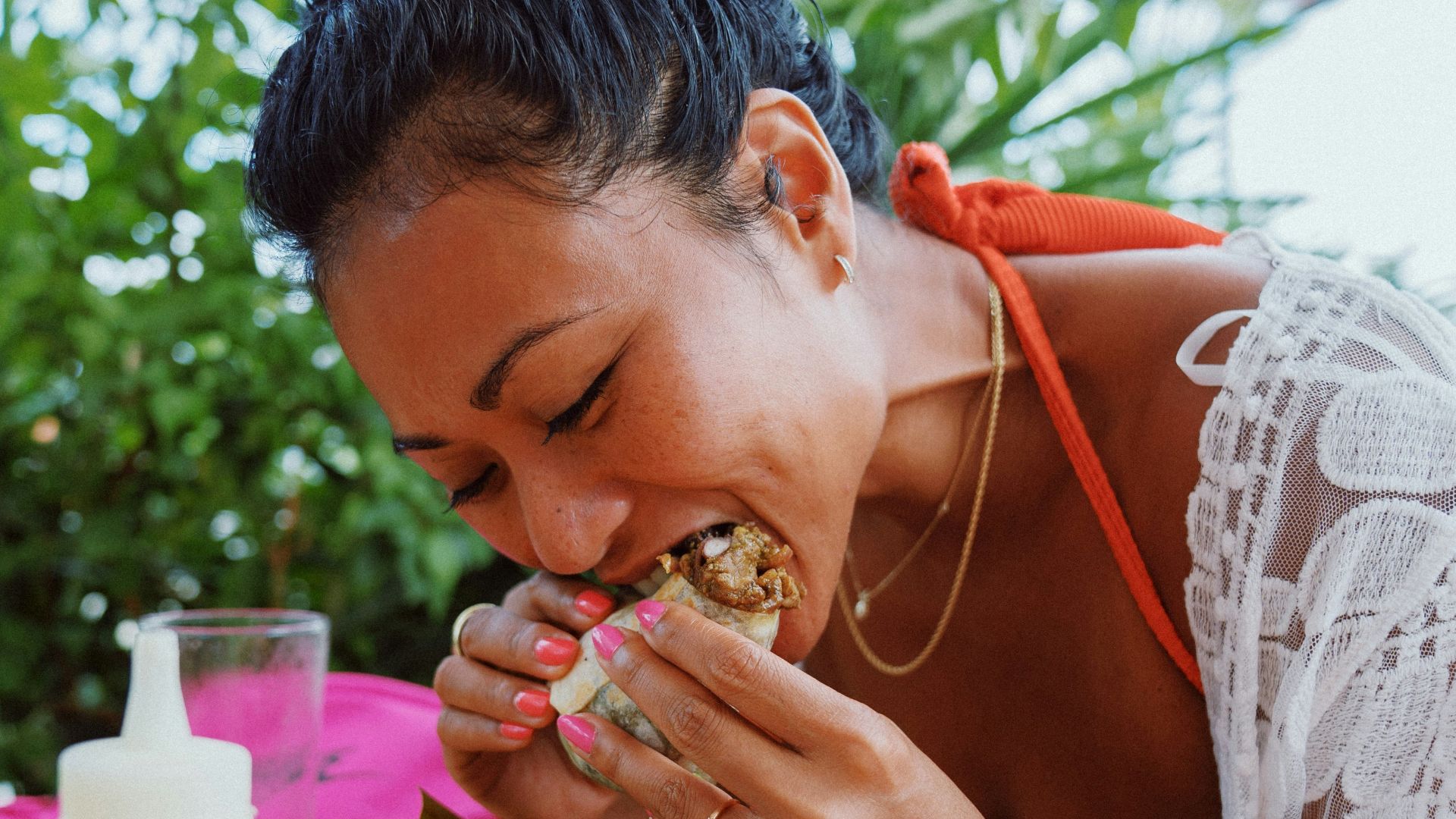 woman in white lace shirt holding brown woven basket