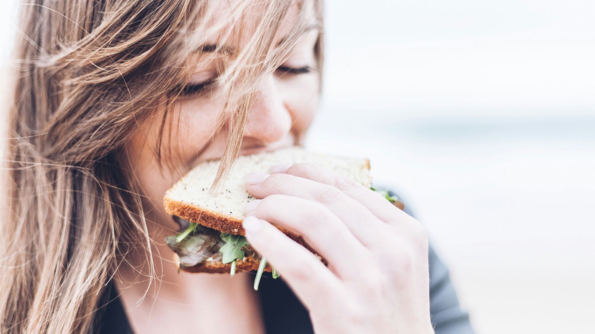 woman eating sandwich