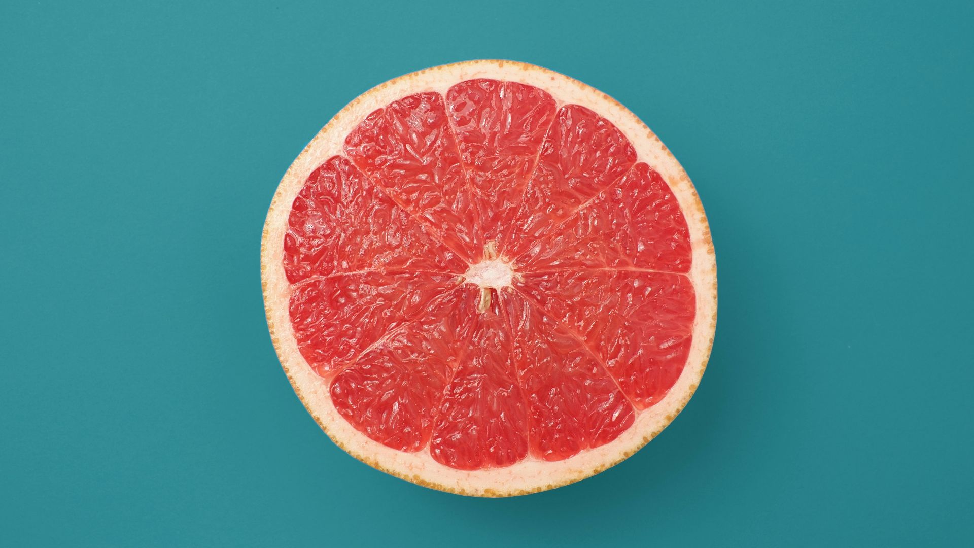 sliced orange fruit on blue background