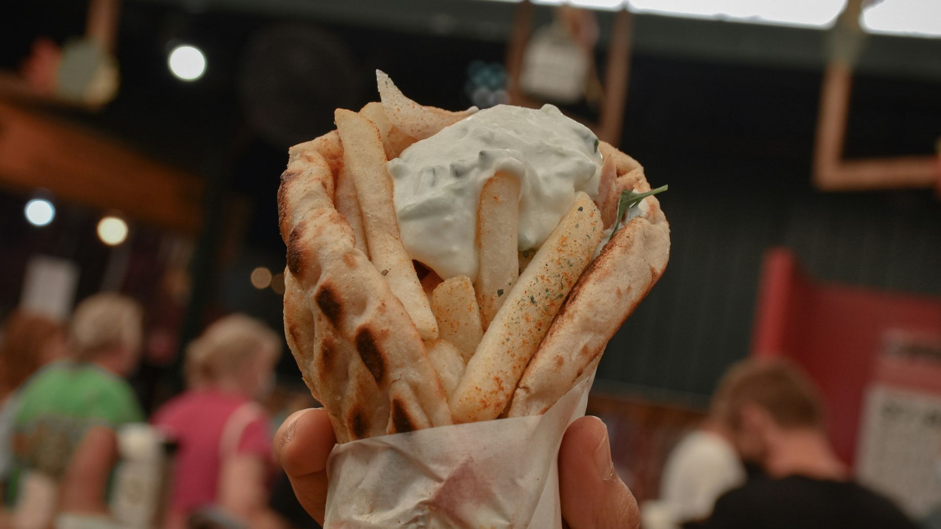 a person holding a bag of food in their hand