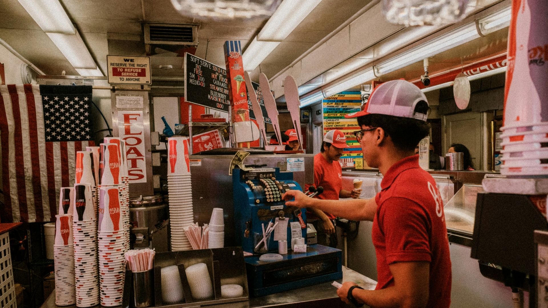 a man standing at a counter in a fast food restaurant
