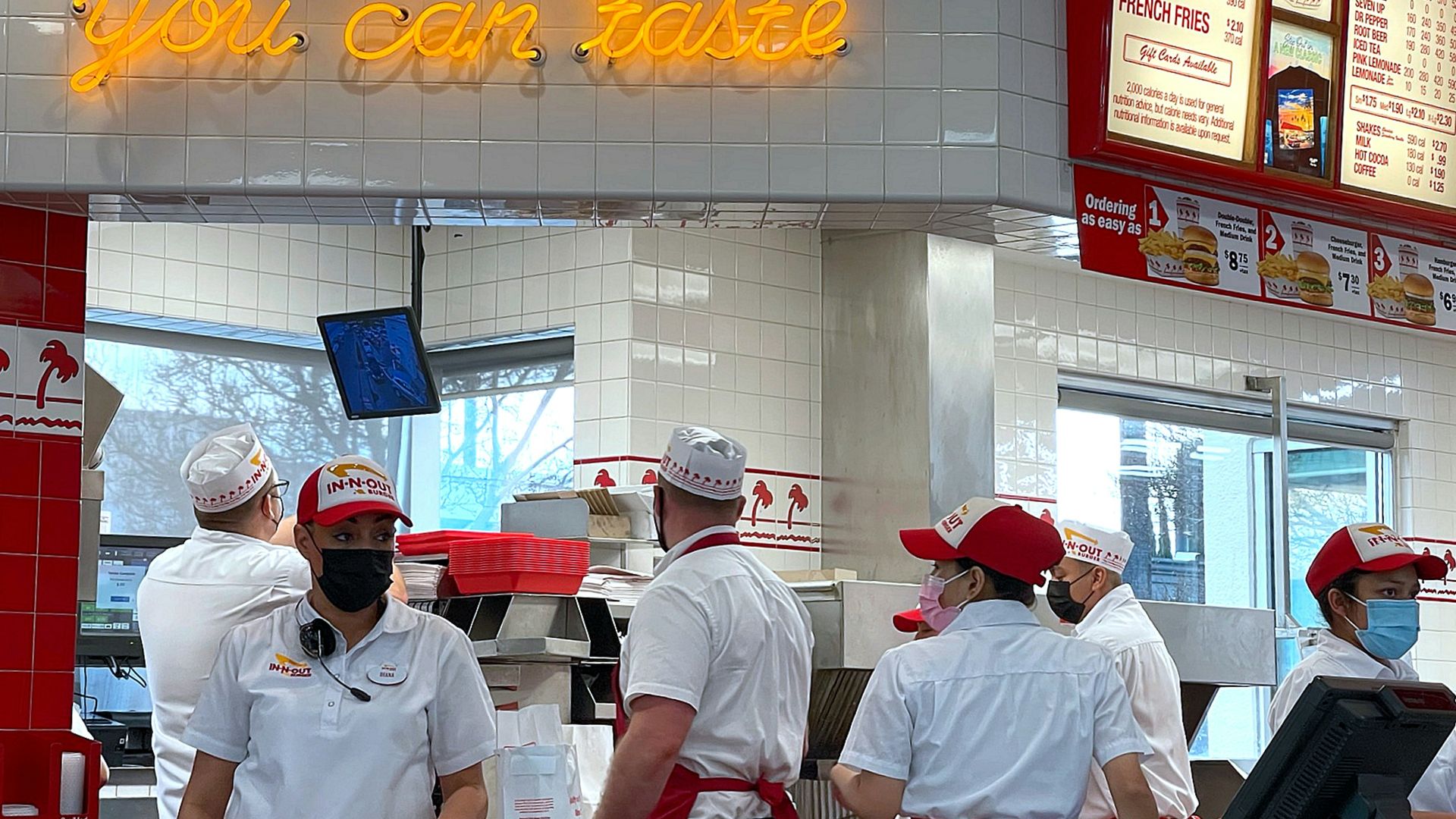 a group of people standing in line at a fast food restaurant