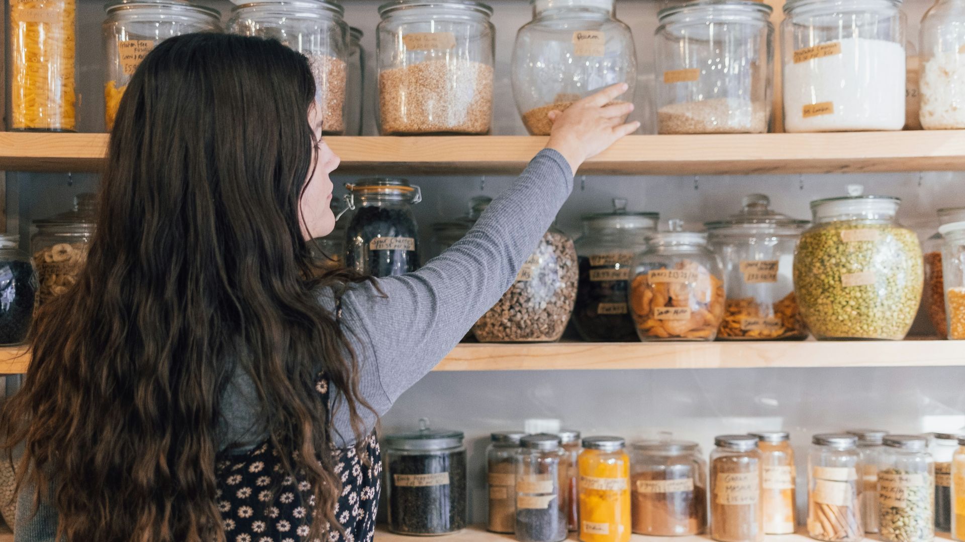 a person holding a jar of food